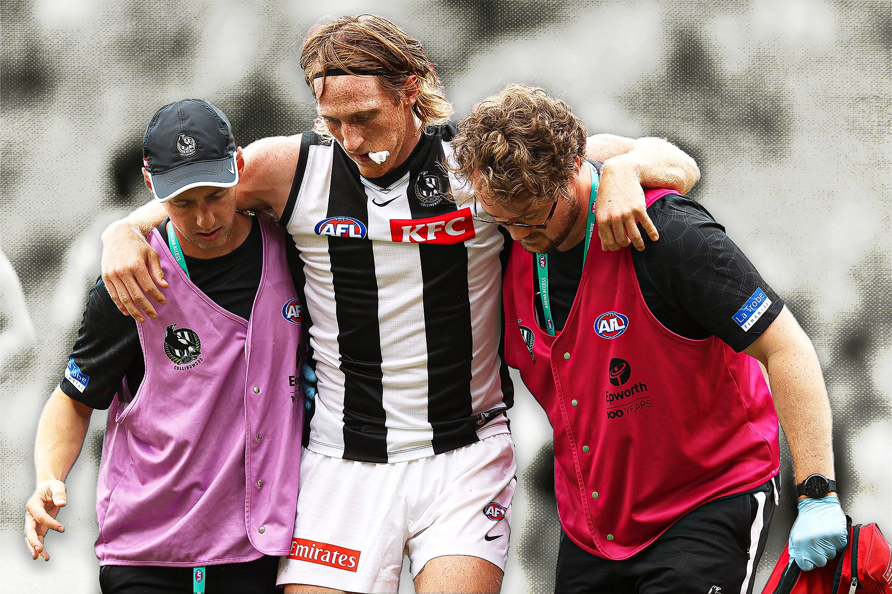 Collingwood defender Nathan Murphy is helped from the field.