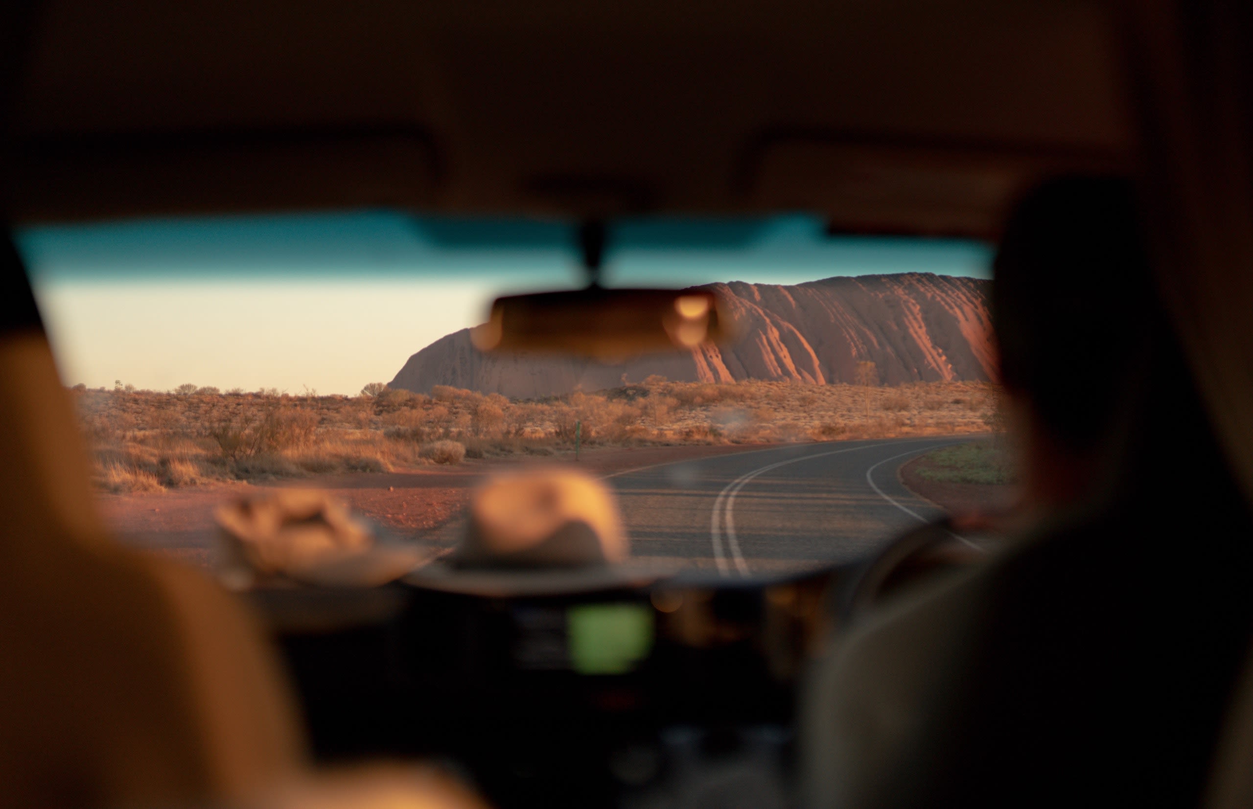 People driving a car near Uluṟu, Mutitjulu, Australia.