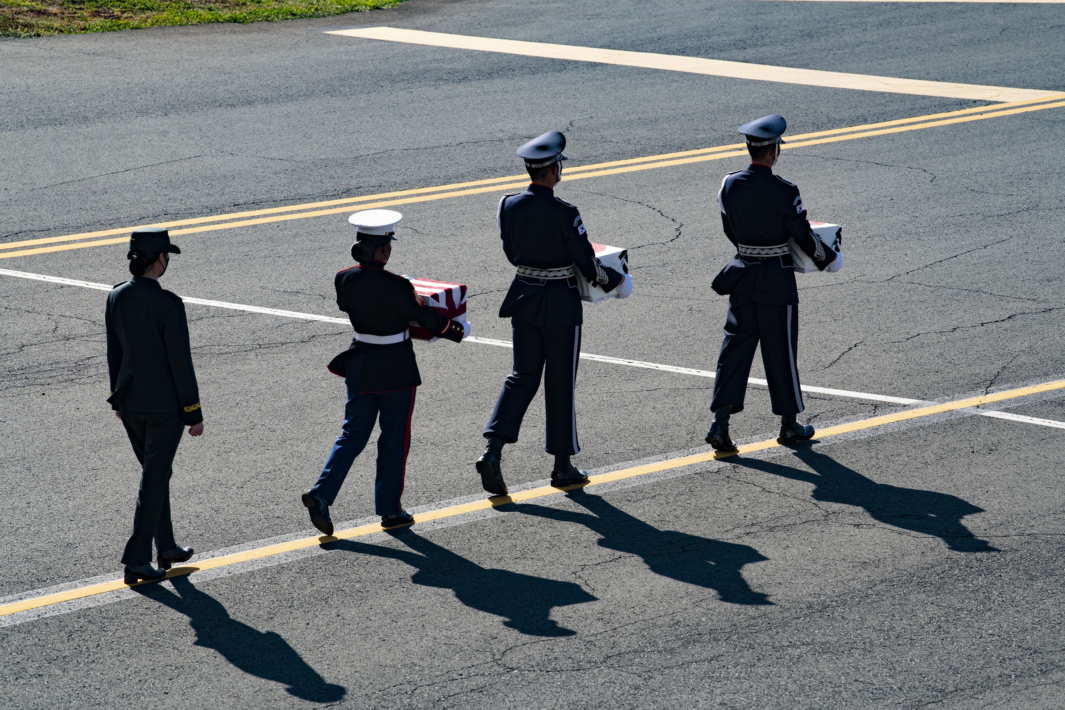 Service members with the United Nations Honor Guard carry remains during the Korean War Remains Joint Repatriation Ceremony at Joint Base Pearl Harbor-Hickam, Hawaii, Sept. 22, 2021. The purpose of the ceremony was to transfer the remains and commemorate the service of 68 fallen South Korean, and believed to be six U.S service members who fought during the Korean War. The remains were analyzed jointly by the DPAA laboratory and scientists with the Republic of Korea's Ministry of National Defense Agency for KIA Recovery and Identification (MAKRI). Working cooperatively, they concluded that the 68 individual remains are of South Korean origin, though the remains haven’t been individually identified. (U.S. Army photo by Staff Sgt. Michael O'Neal)