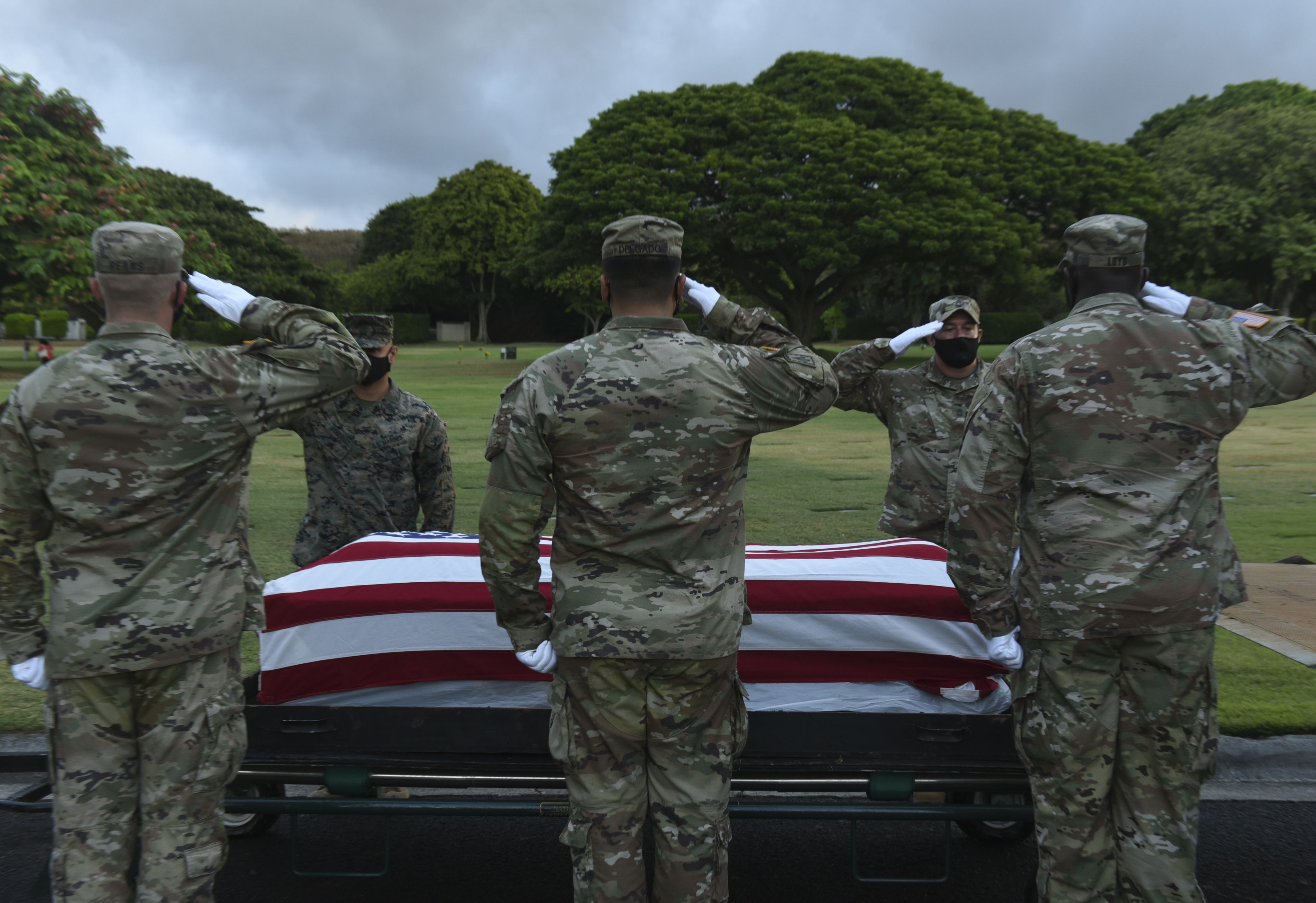 Members of the Defense POW/MIA Accounting Agency (DPAA) participate in a disinterment ceremony at the National Memorial Cemetery of the Pacific in Honolulu, Hawaii, Oct. 5, 2020. The ceremony was part of DPAA’s efforts to disinter the remains of unknown service members lost during WWll. DPAA’s mission is to provide the fullest possible accounting of missing personnel to their families and the nation. (U.S. Air Force photo by Staff. Sgt. Apryl Hall)