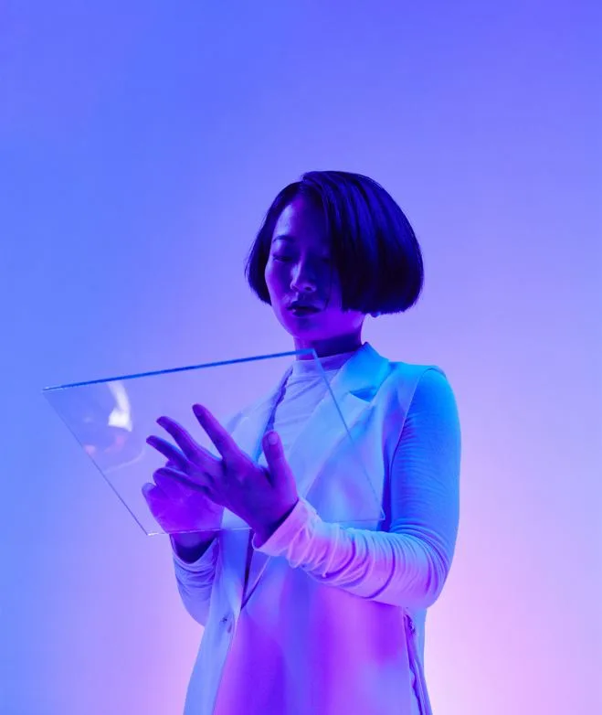 Lady looking at glass tablet with digital data