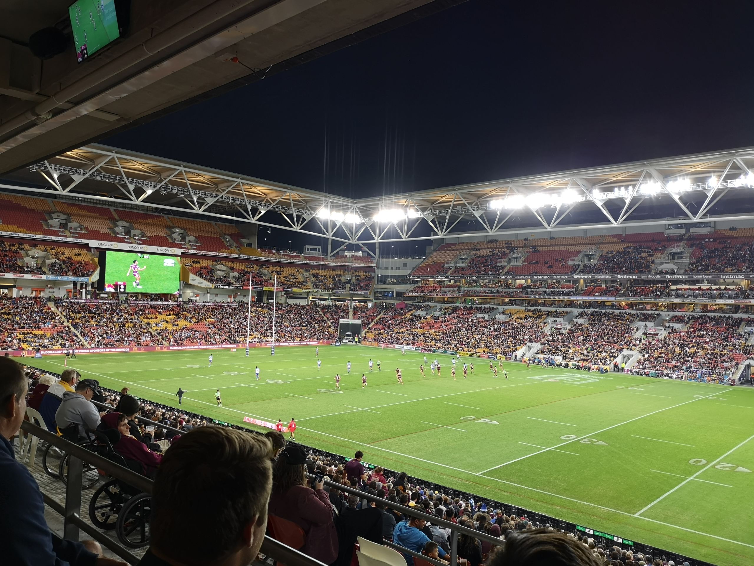 Football team playing at Suncorp Stadium.
