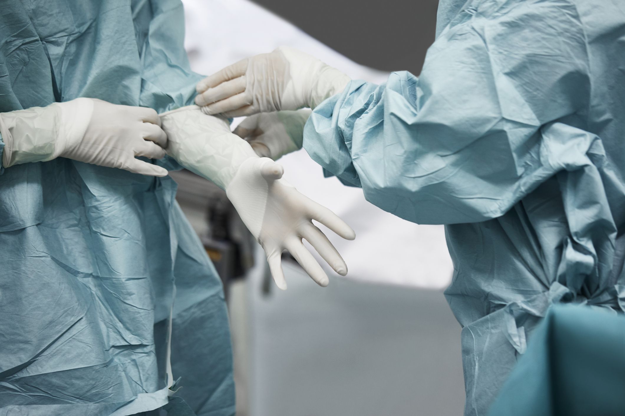 Medical surgeons putting on gloves preparing for surgery