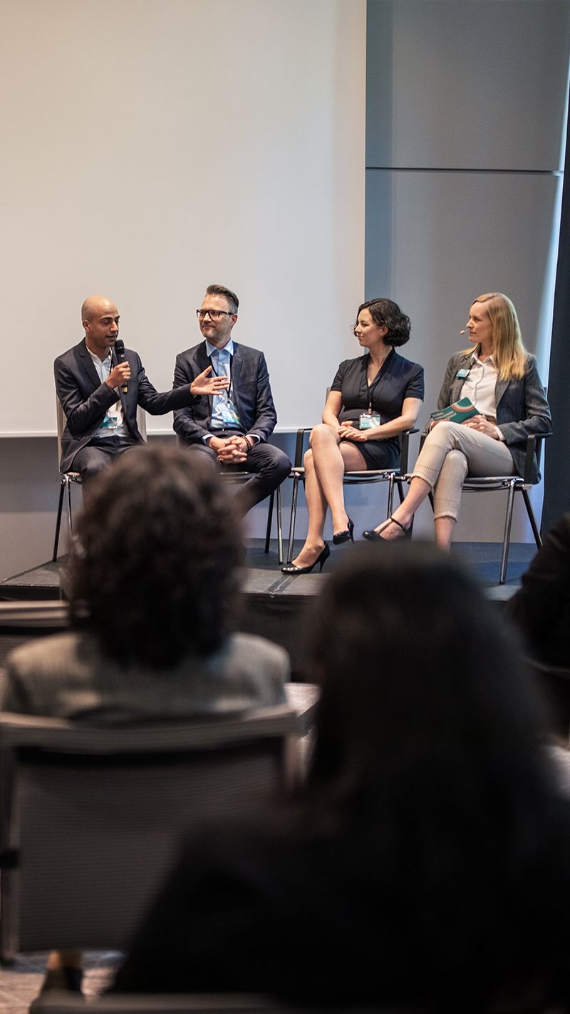 Group of people presenting at a conference.