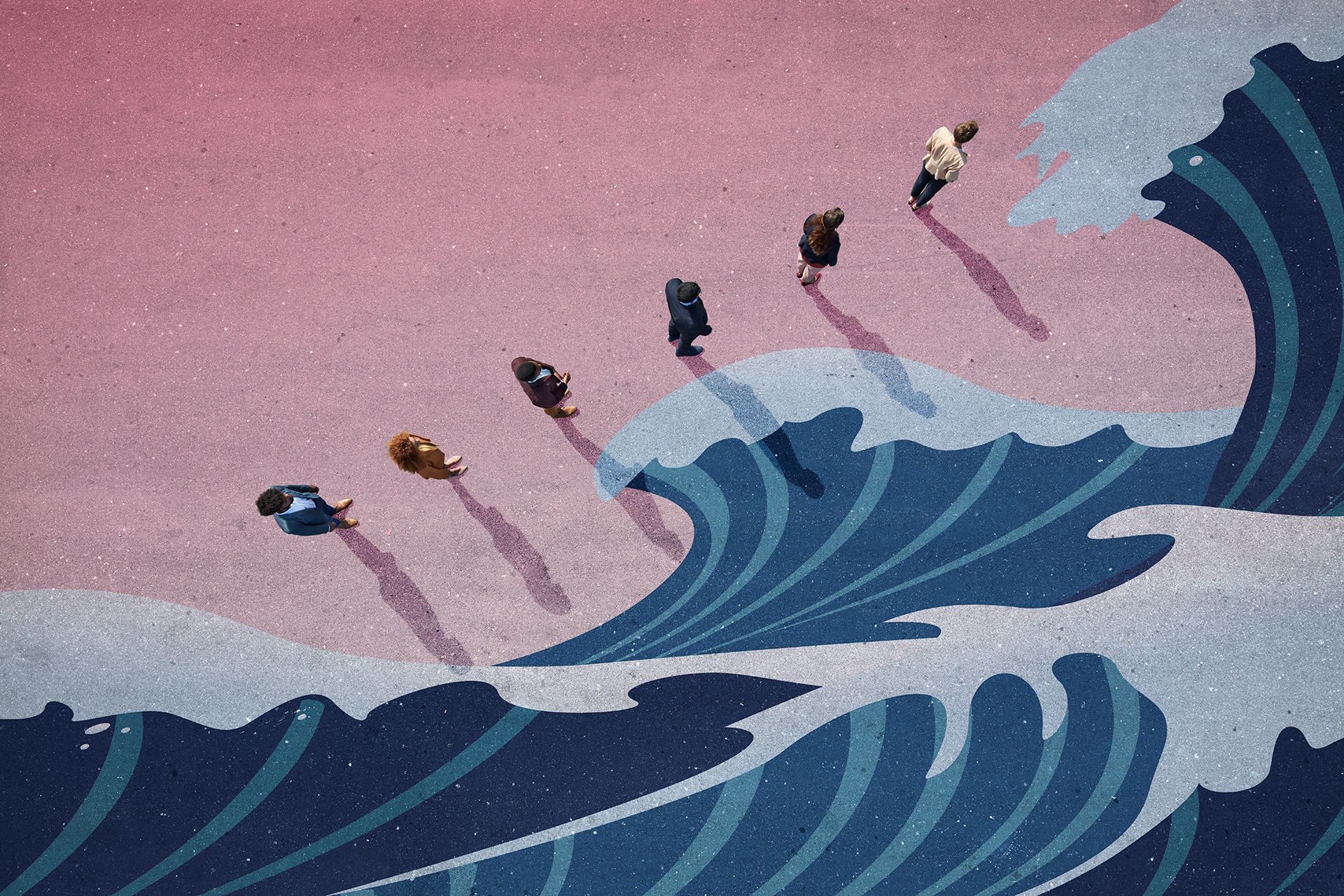 Business people standing in front of a wave.