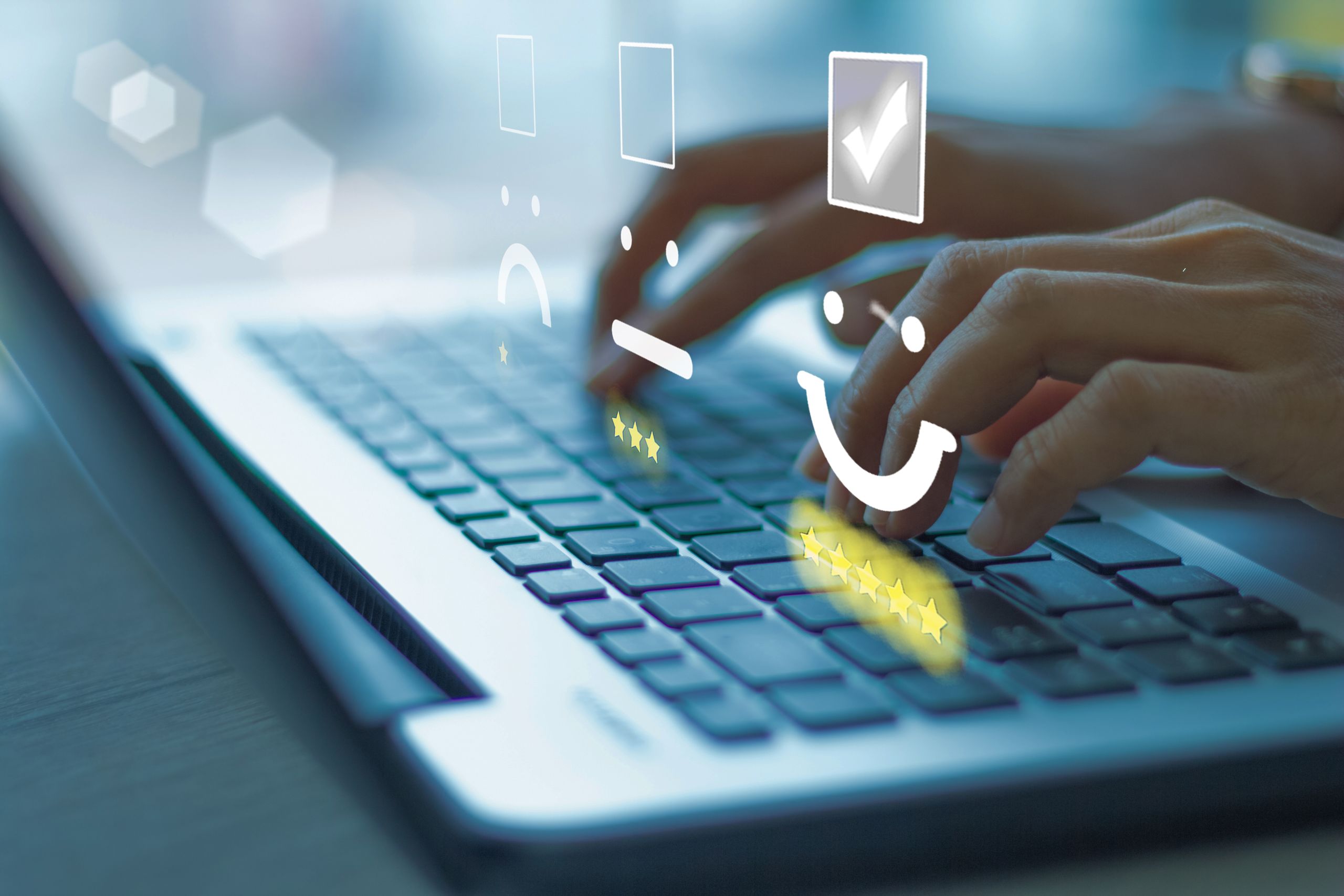 Hand on a laptop keyboard with visual representations of unhappy, neutral and happy user experiences