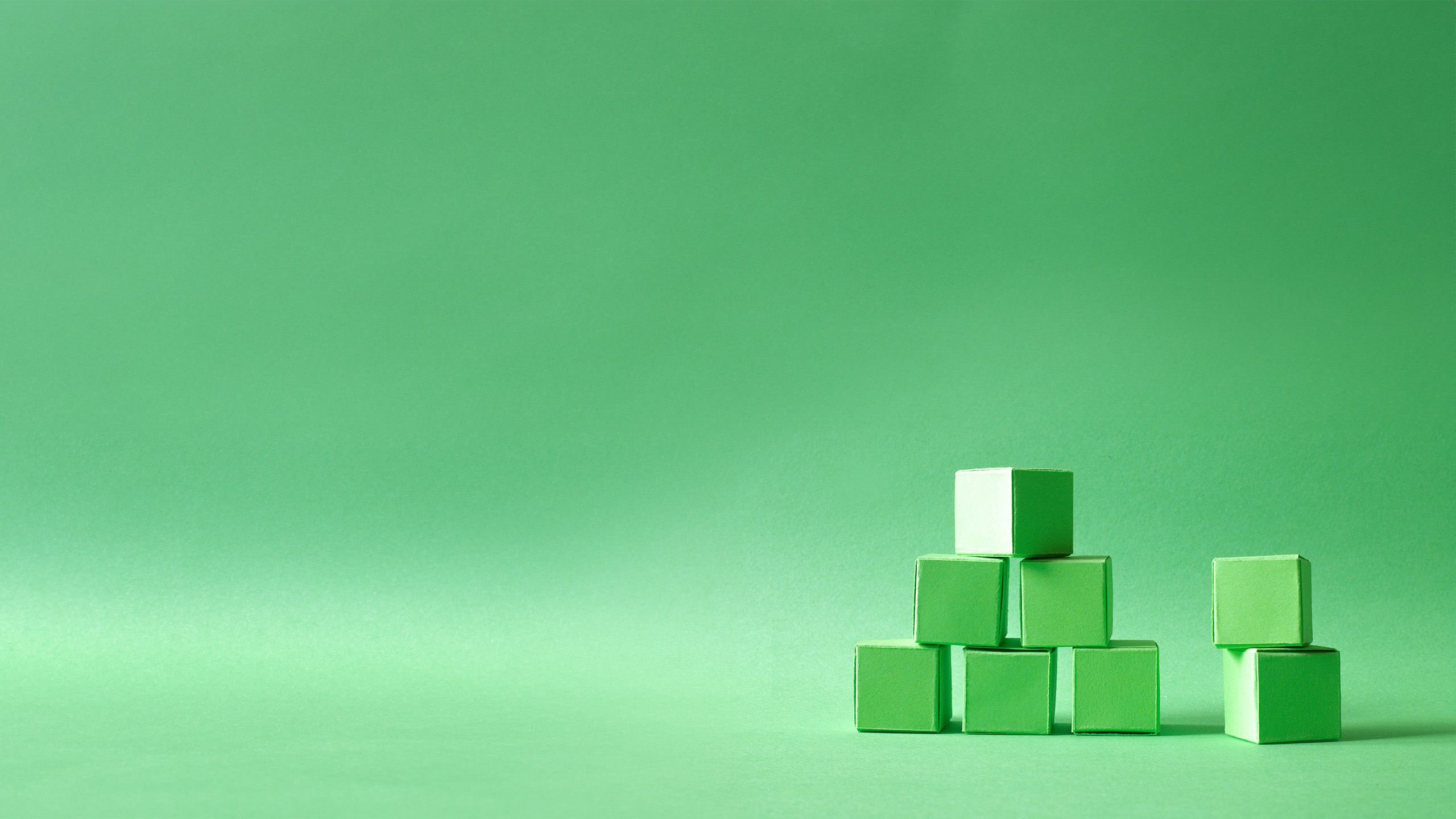 Green cubes organised in a pyramid formation on a green background