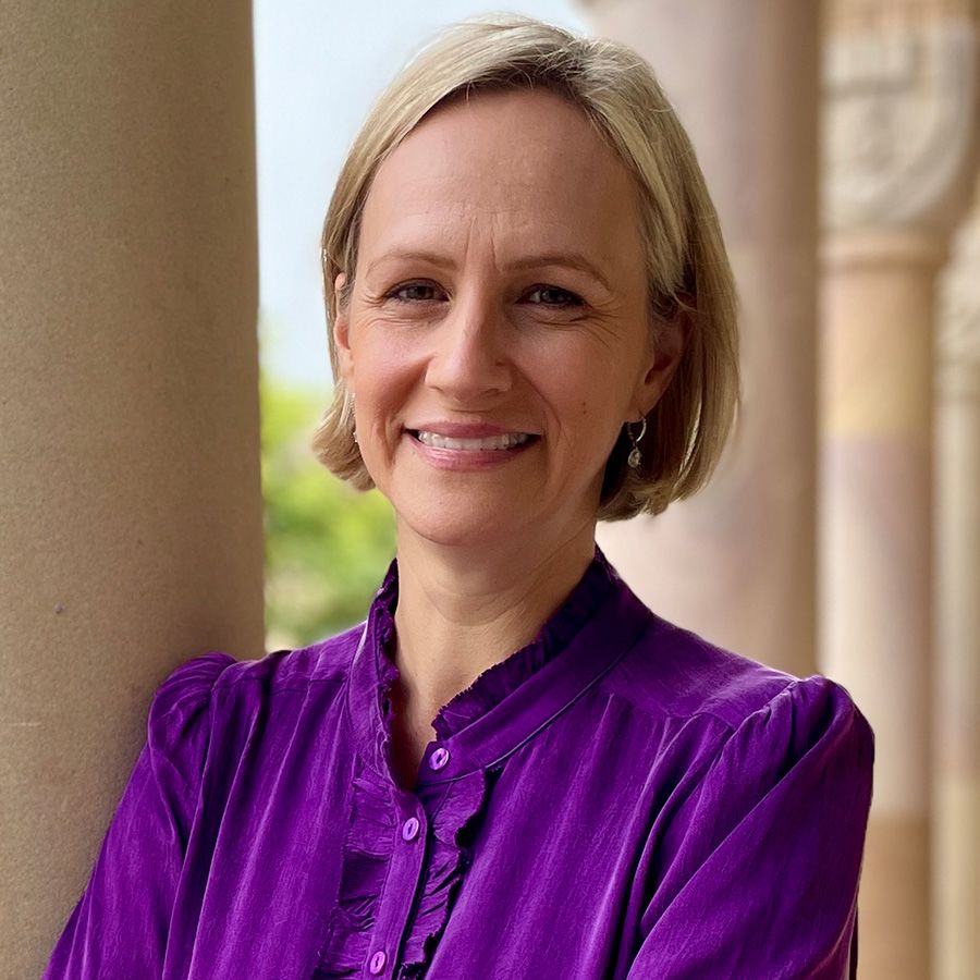 An image of Dr Miriam Moeller, a woman with short blonde hair standing in front of a sandstone background