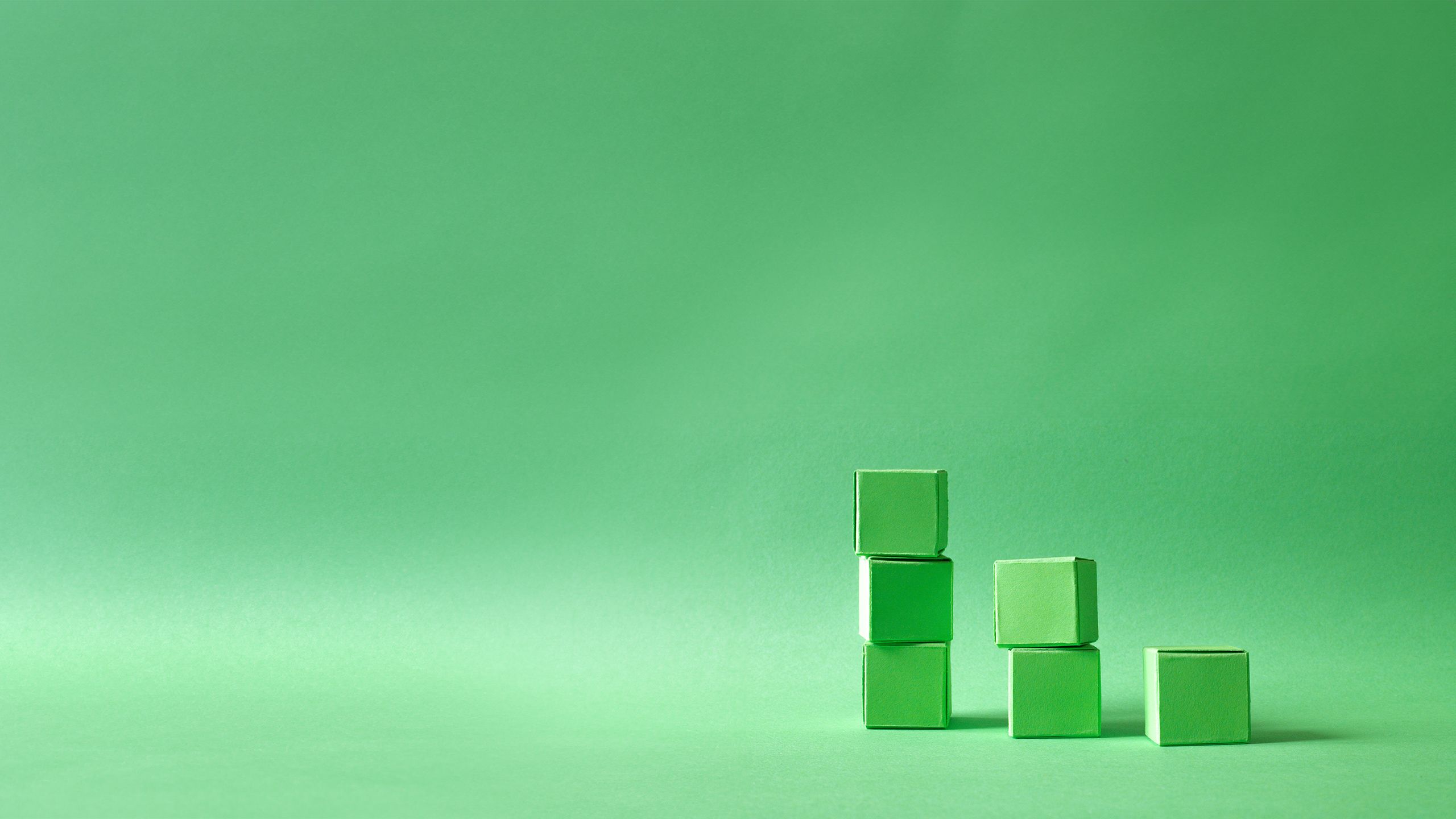 Green cubes stacked on top of each other in front of a green background