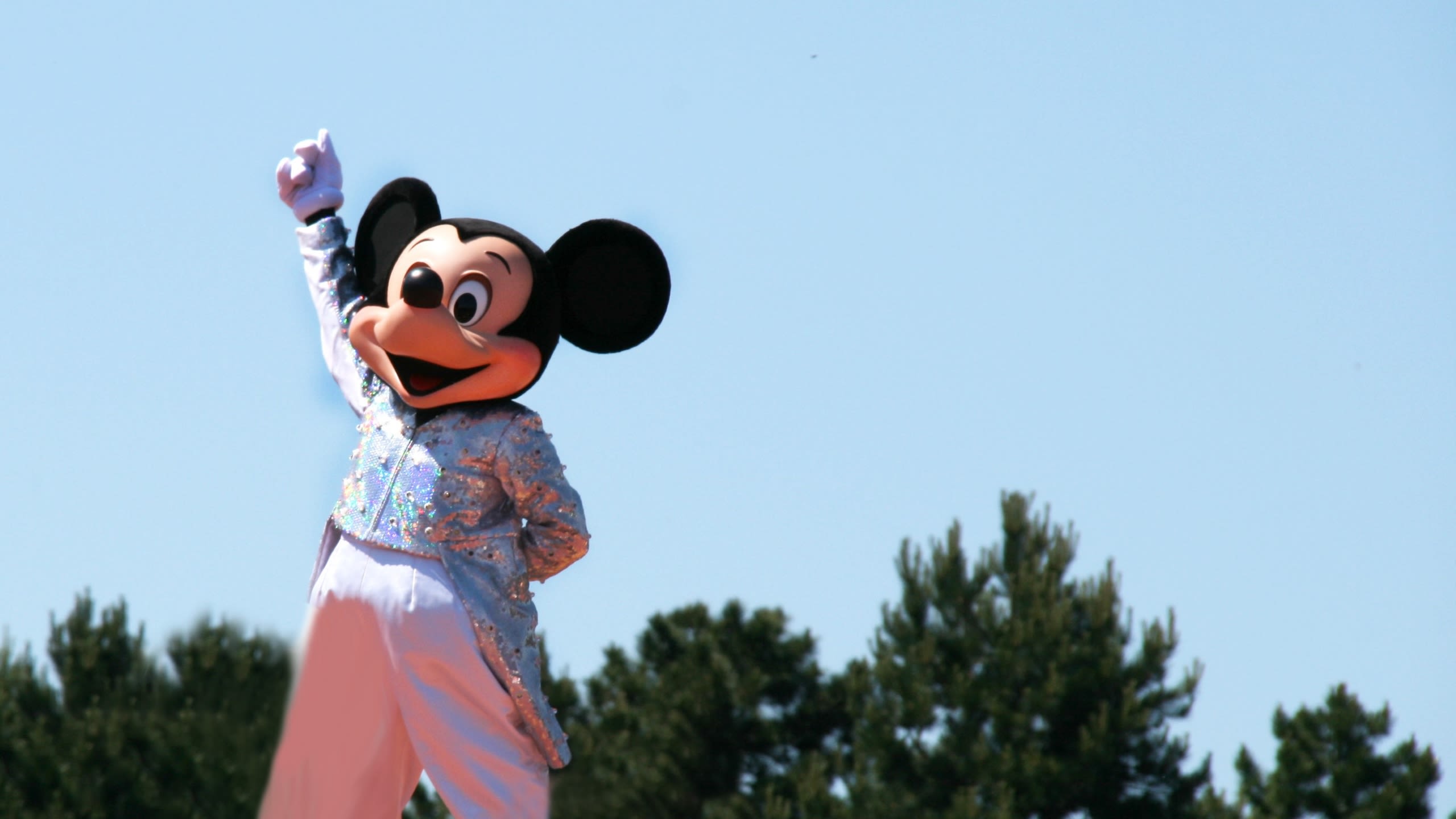 A person wearing a full-body Mickey Mouse costume