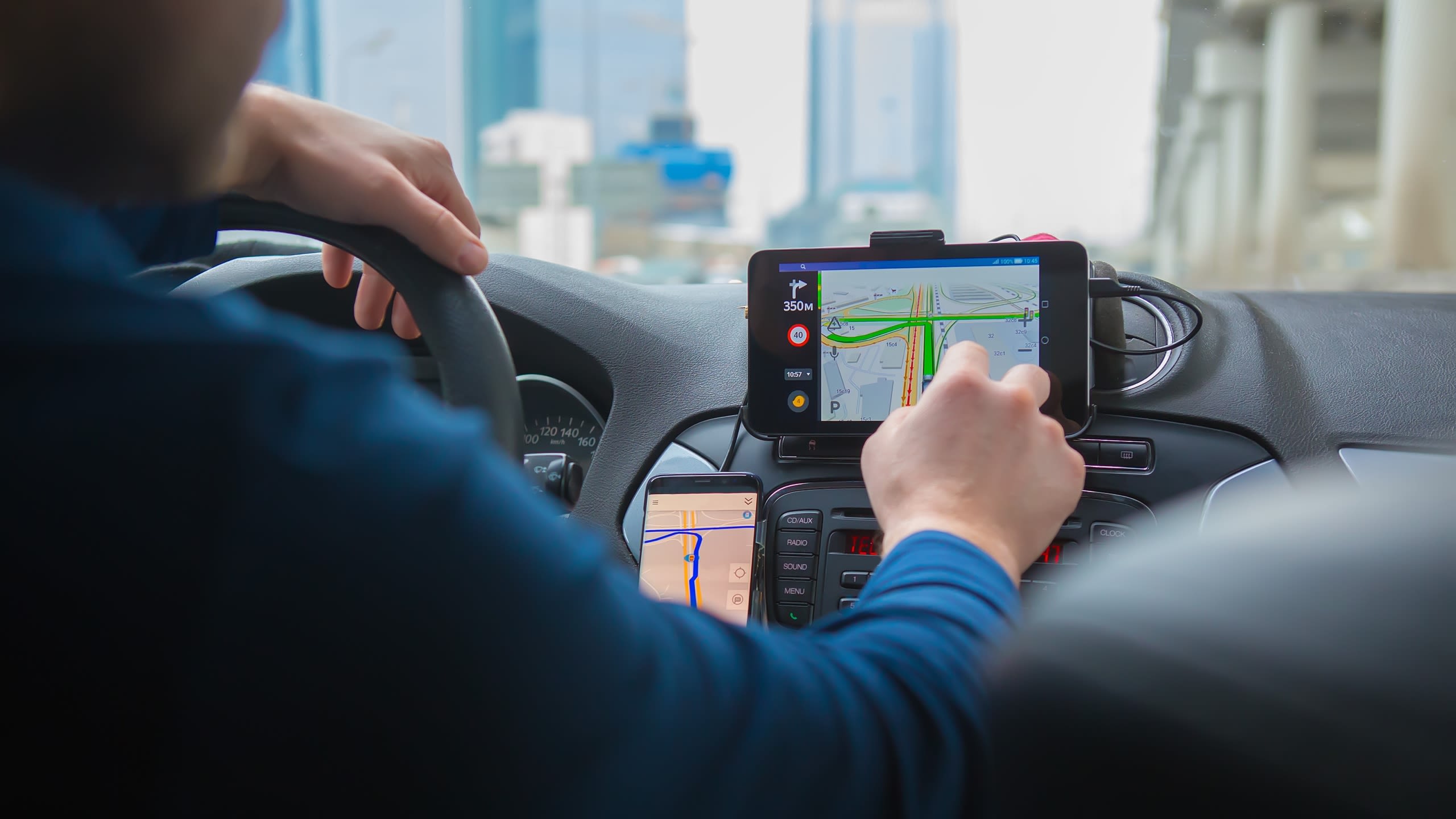A driver using a GPS in a car
