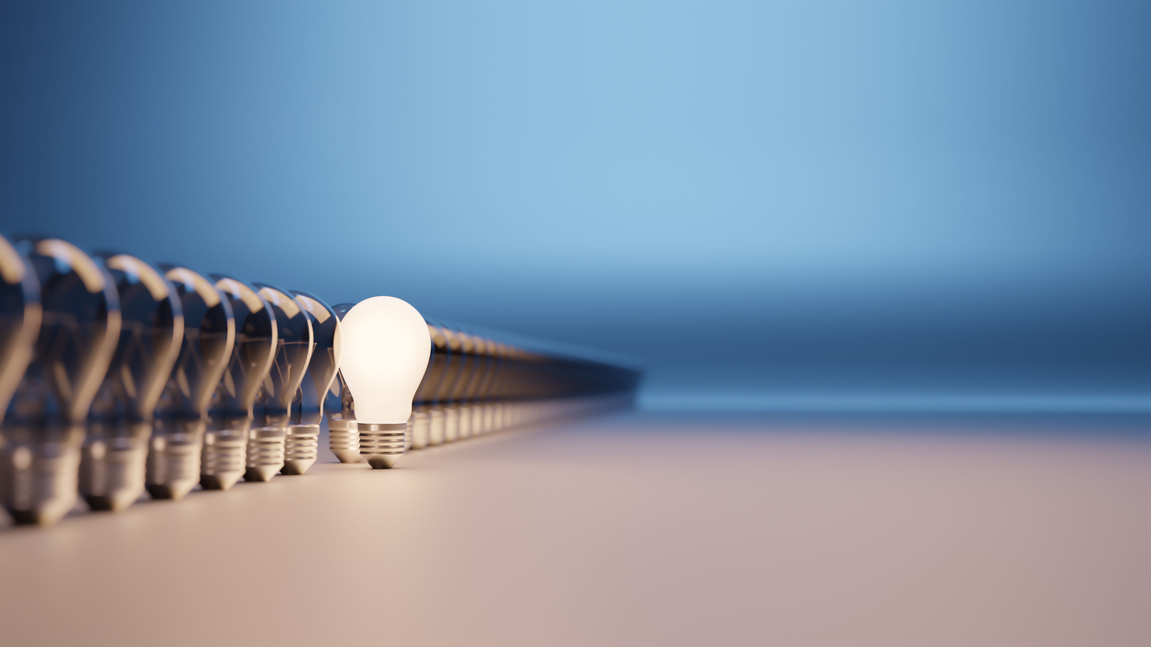 Lights bulbs in a row with one lit and with room for text