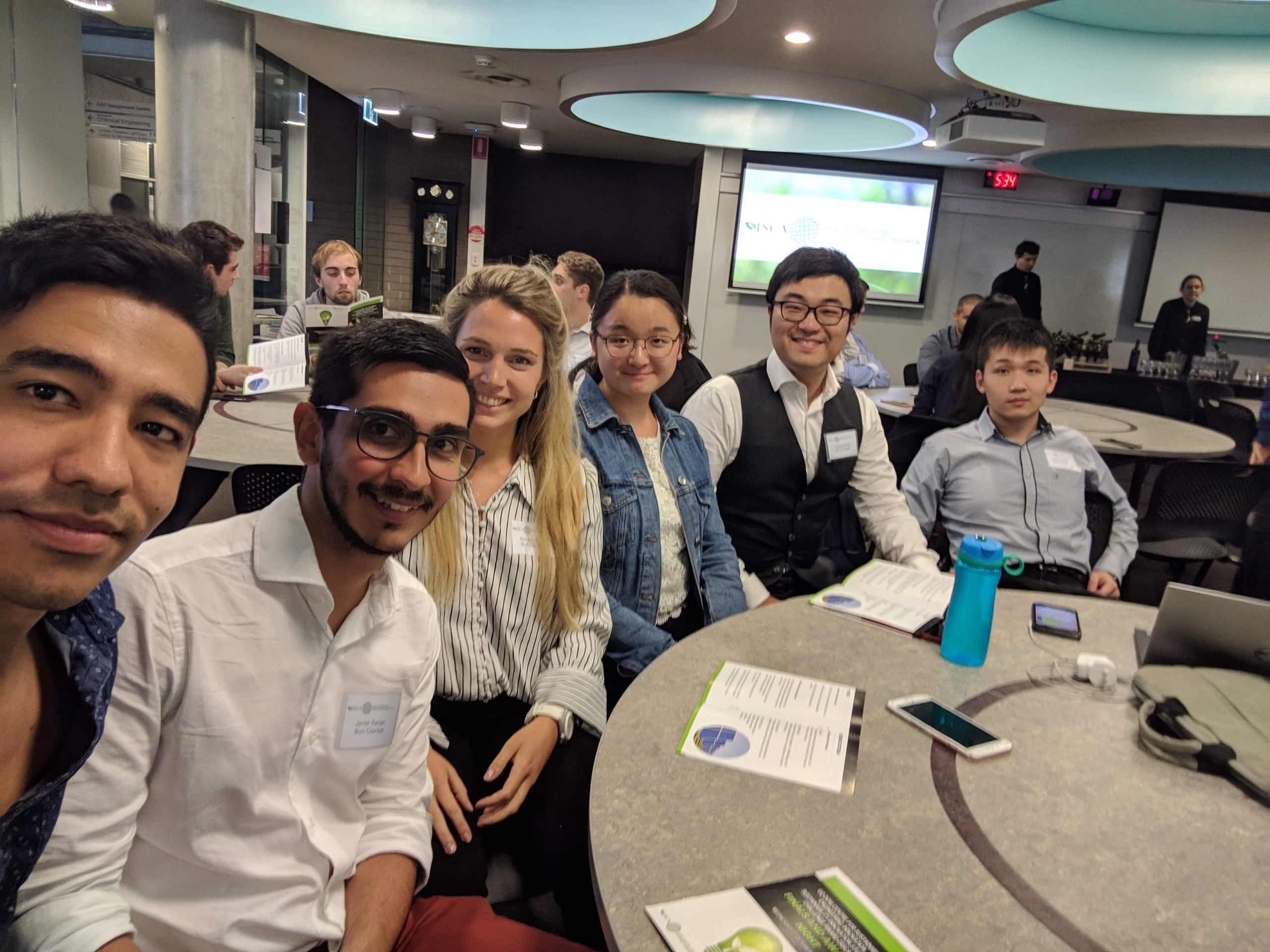 A group of students sitting at a table participating in a competition