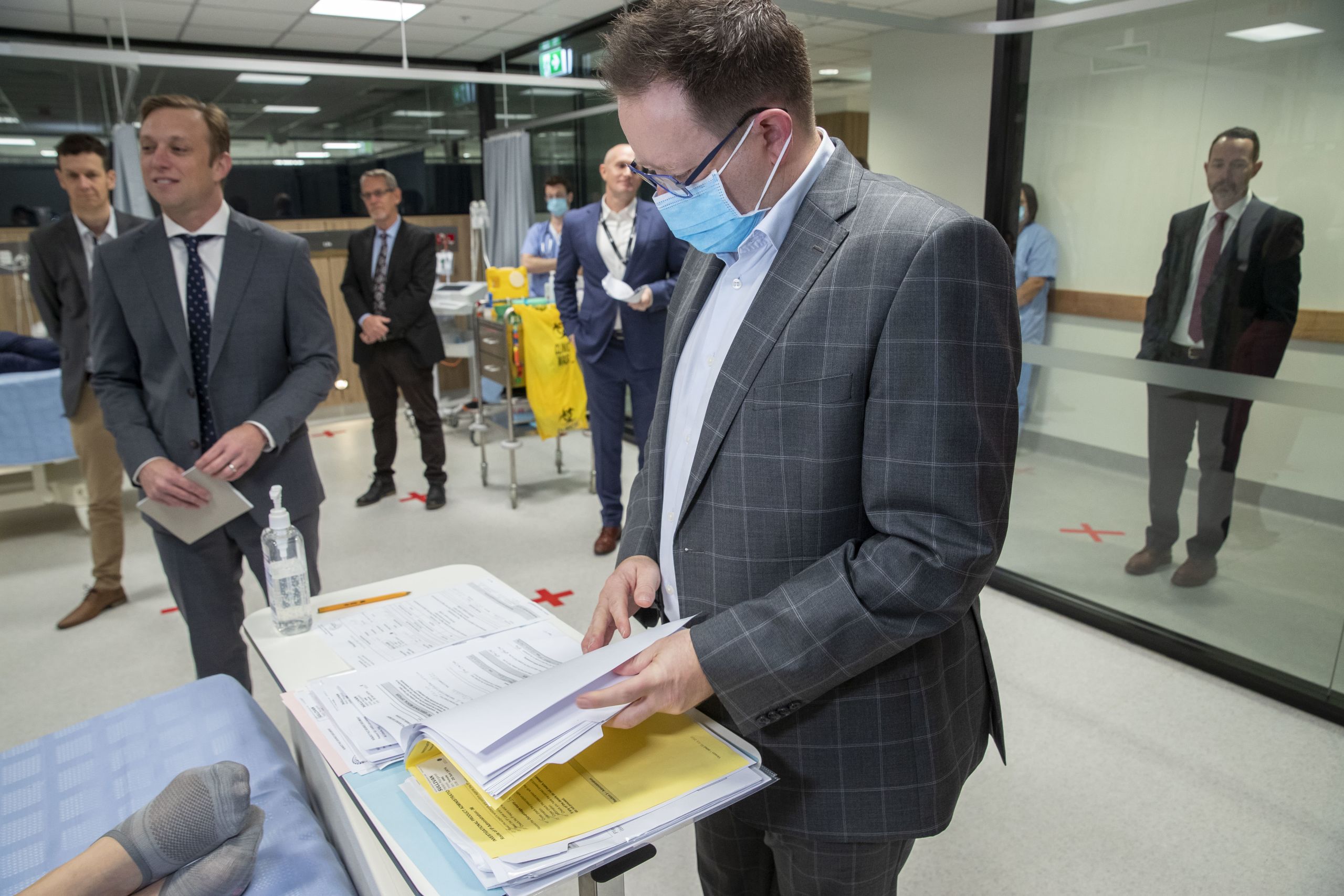 Professor Paul Griffin reads the medical chart of volunteer.