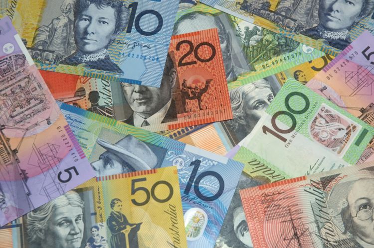 Australian currency in various denominations lying on top of each other