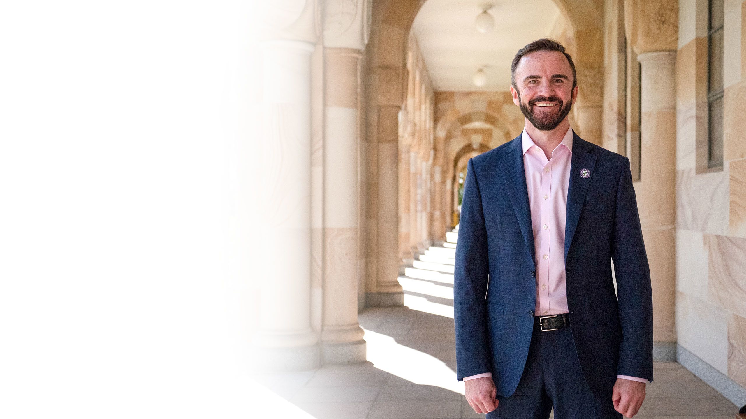 Professor Stuart Carney photographed against UQ's sandstone buildings at the St Lucia campus.