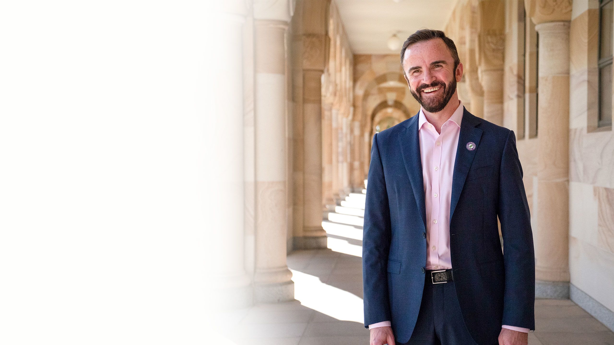 Professor Stuart Carney photographed against UQ's sandstone buildings at the St Lucia campus.