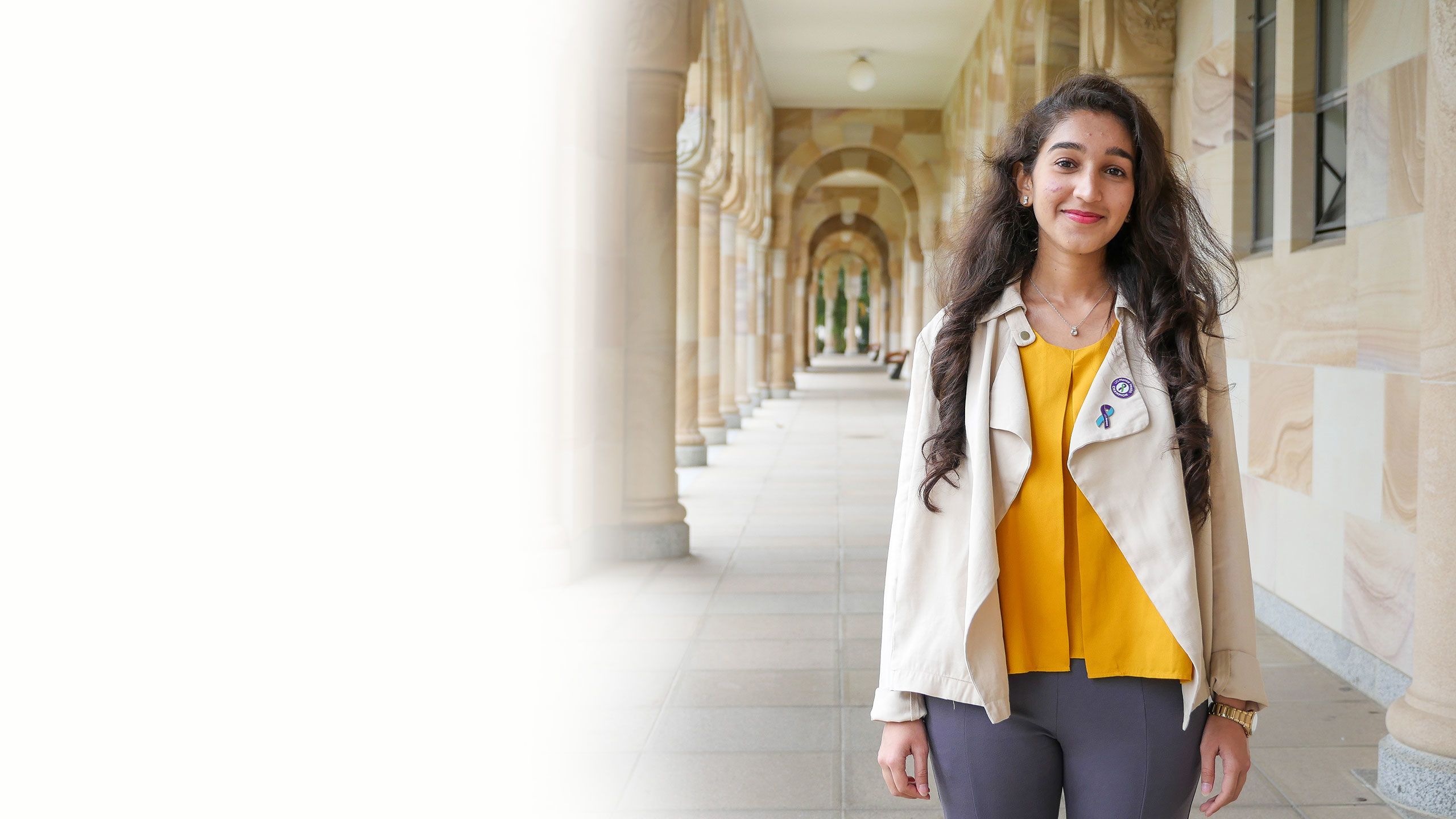 Staff and students photographed against UQ's sandstone buildings at the St Lucia campus.