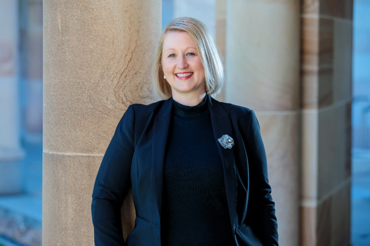 Belinda Bern photographed against UQ's sandstone buildings at the St Lucia campus.