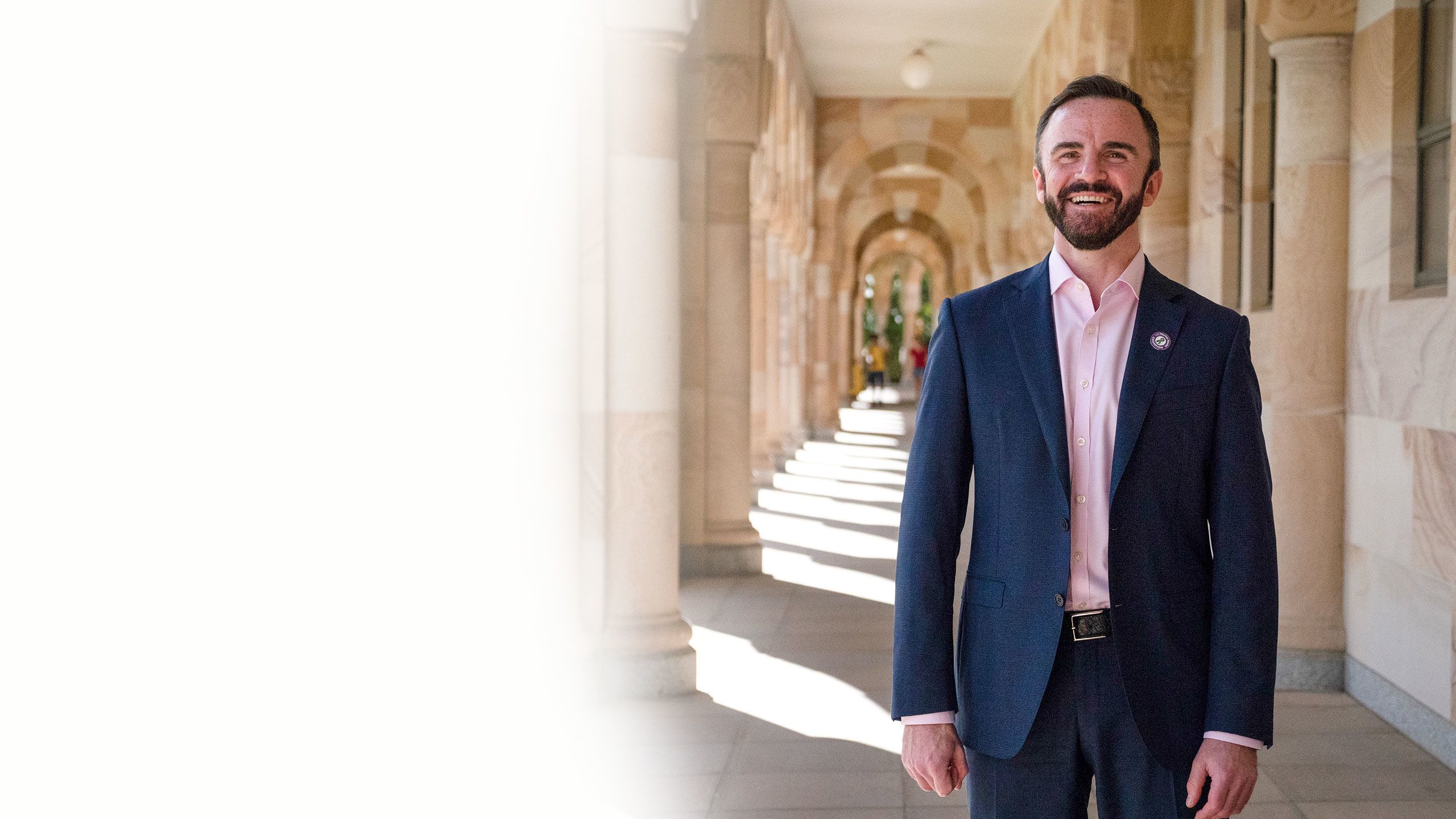 Professor Stuart Carney photographed against UQ's sandstone buildings at the St Lucia campus.