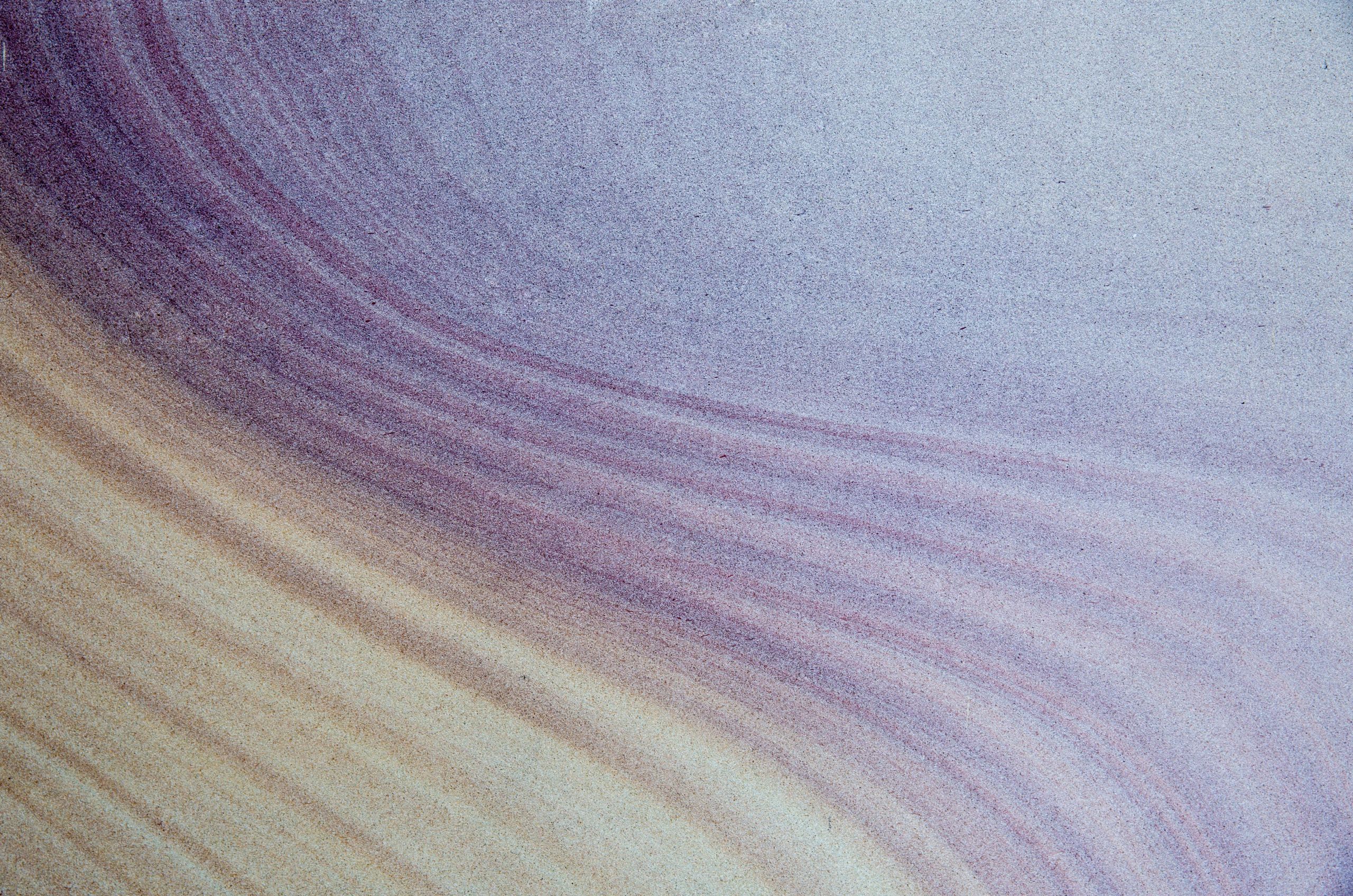 Close up on sandstone in UQ's Great Court, purple and cream in colour