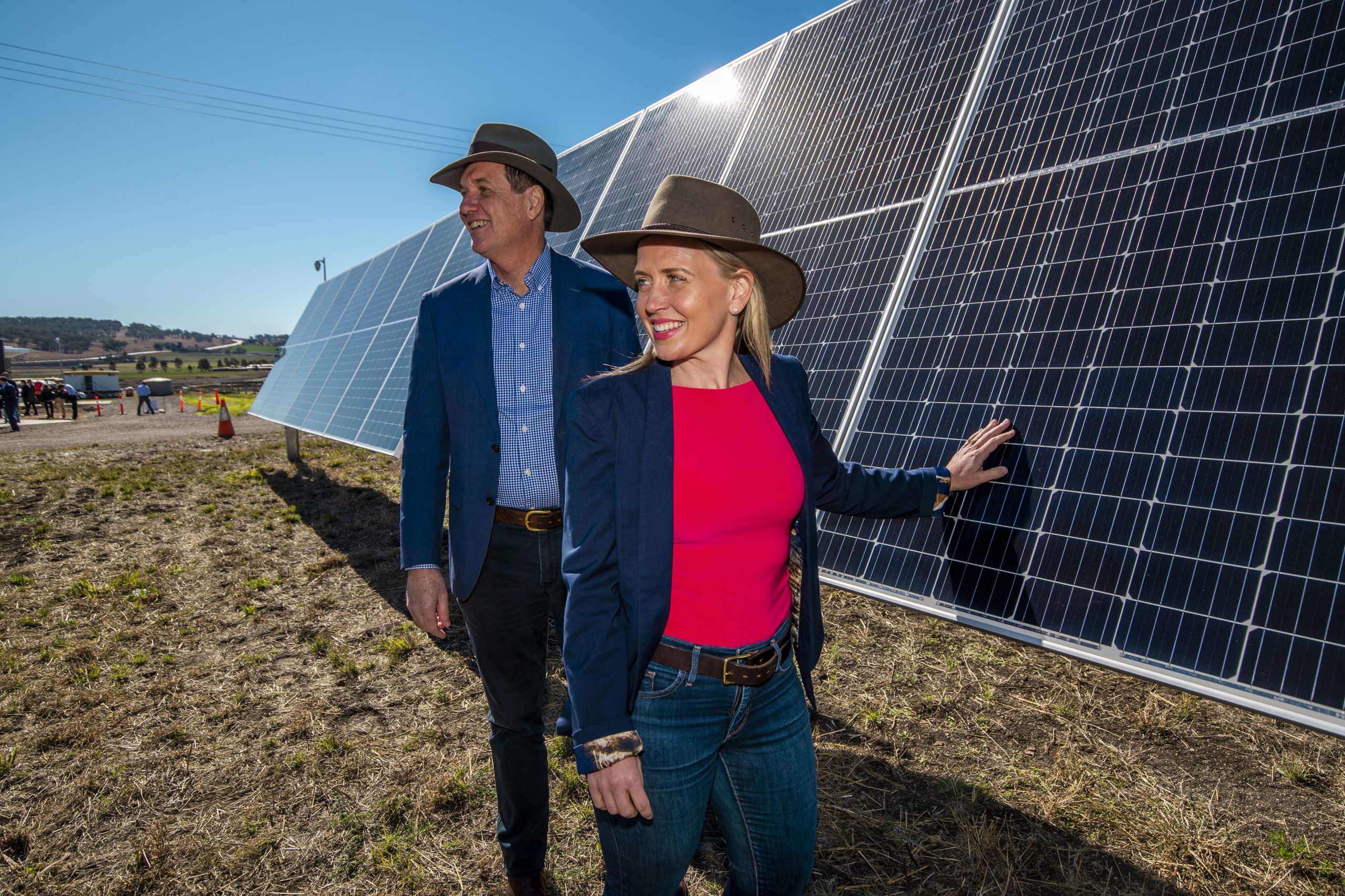 Minister for Natural Resources, Mines and Energy Anthony Lynham and Minister for State Development, Tourism and innovation Kate Jones touching one of the solar panels.