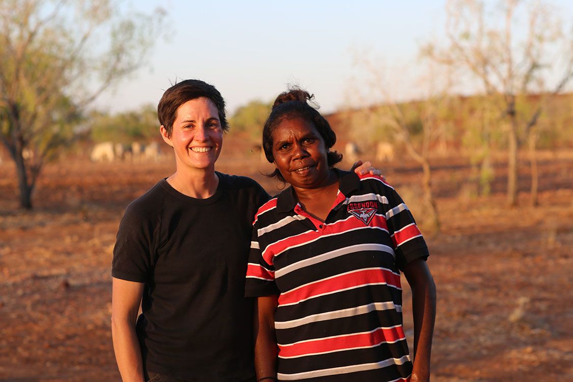 Professor Felicity Meakins with her arm around Cassandra Algy in a remote Australian setting