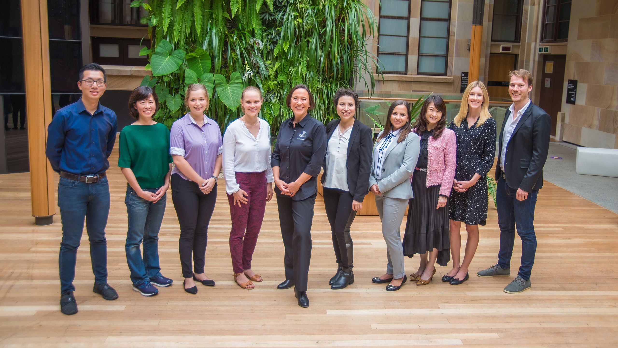 Sara Dolnicar and her research team standing in an outdoor courtyard