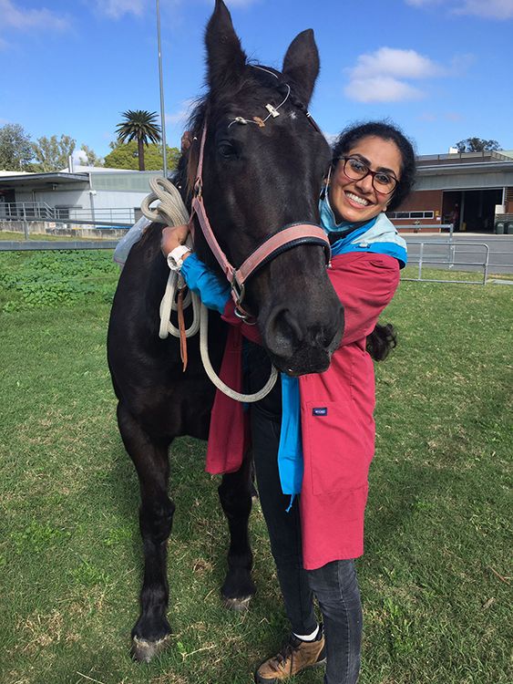 Anjali Krishnaa Warrier with her arms around a horse
