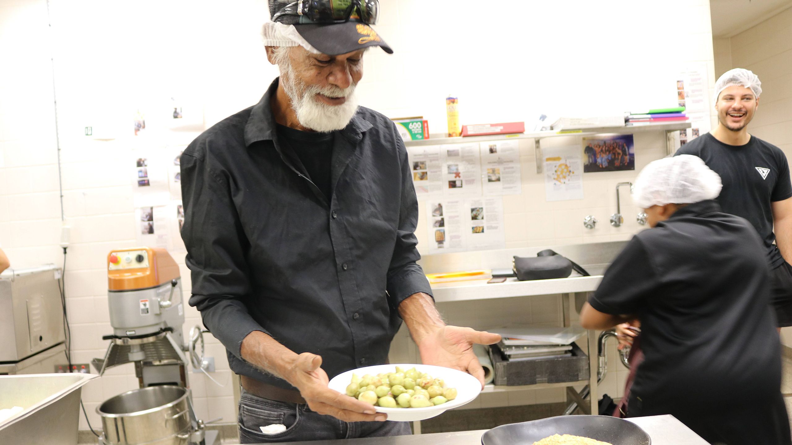 Man looking at container of Kakadu plums