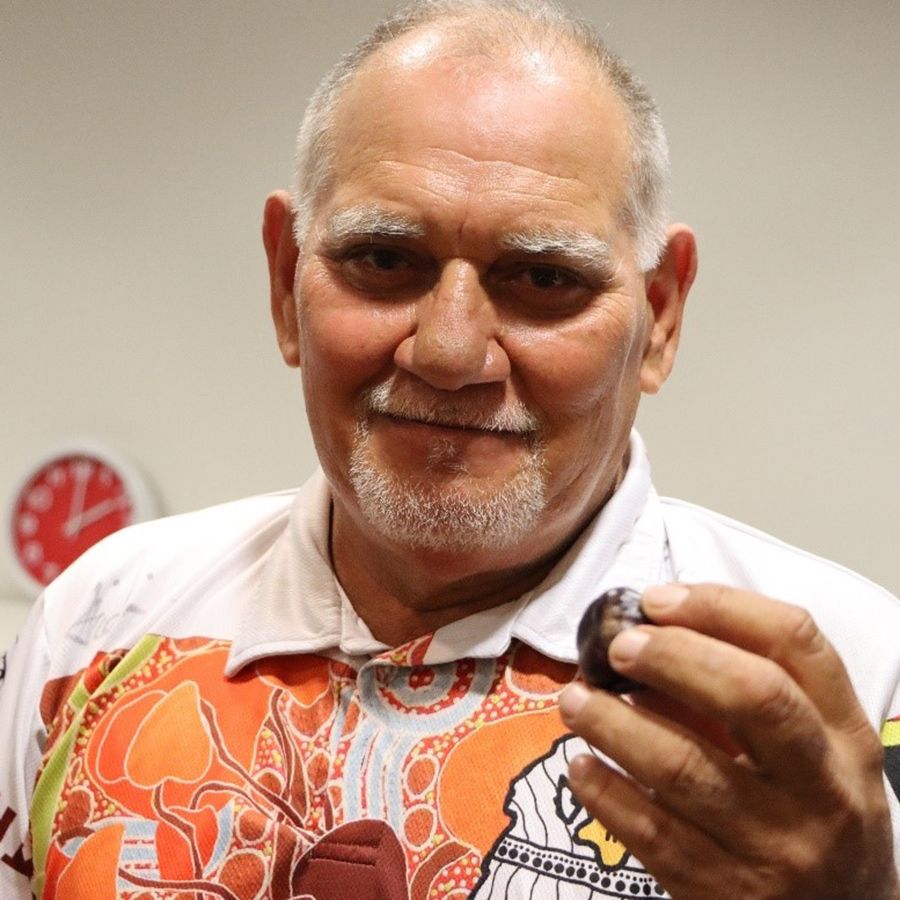 Djungan Paul Neal holds Burdekin plum, Image: M. Puls