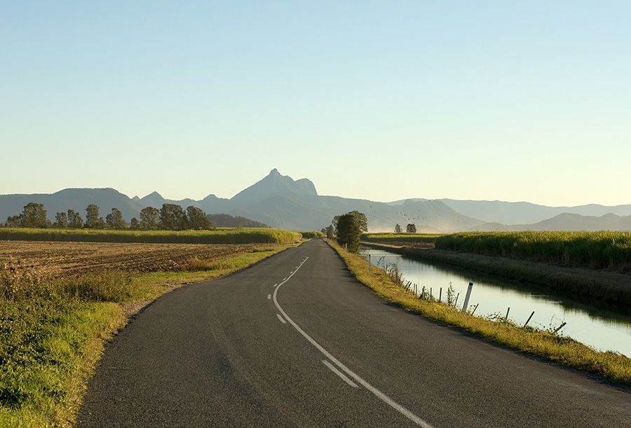 A road leading up to a mountain range.