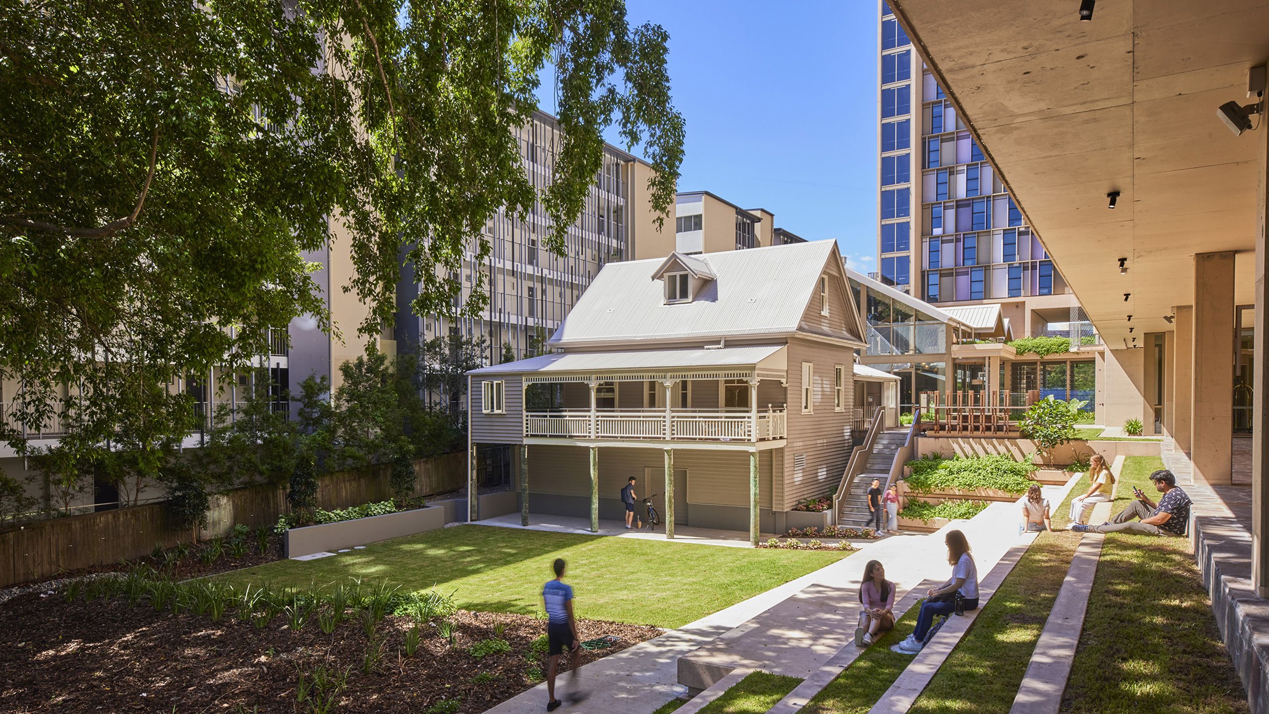 An old Queenslander house overlooking grass and a garden