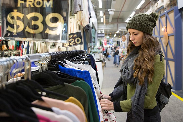 A woman browsing clothes at South Melbourne Market