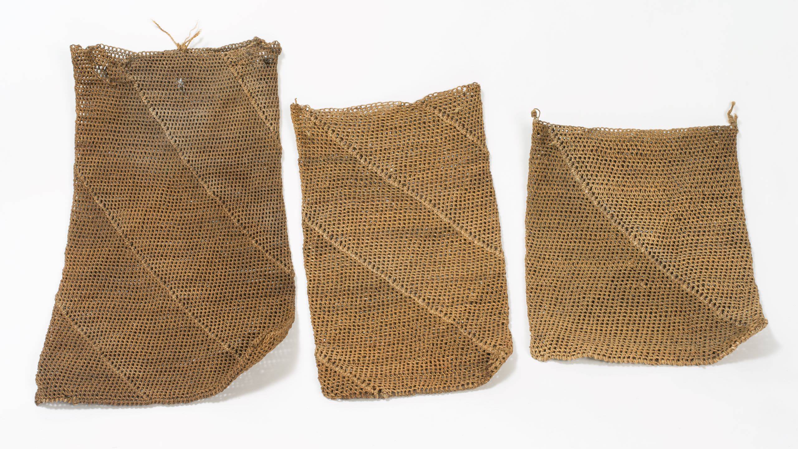 Three woven bags in a row, all with a diagonal design