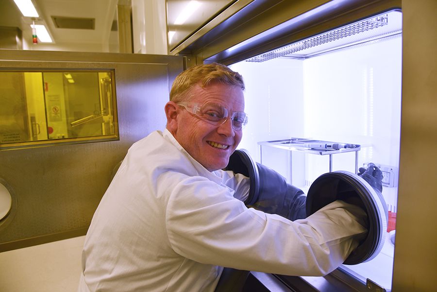 Professor Kris Thurecht working in a laboratory wearing safety goggles and a lab coat