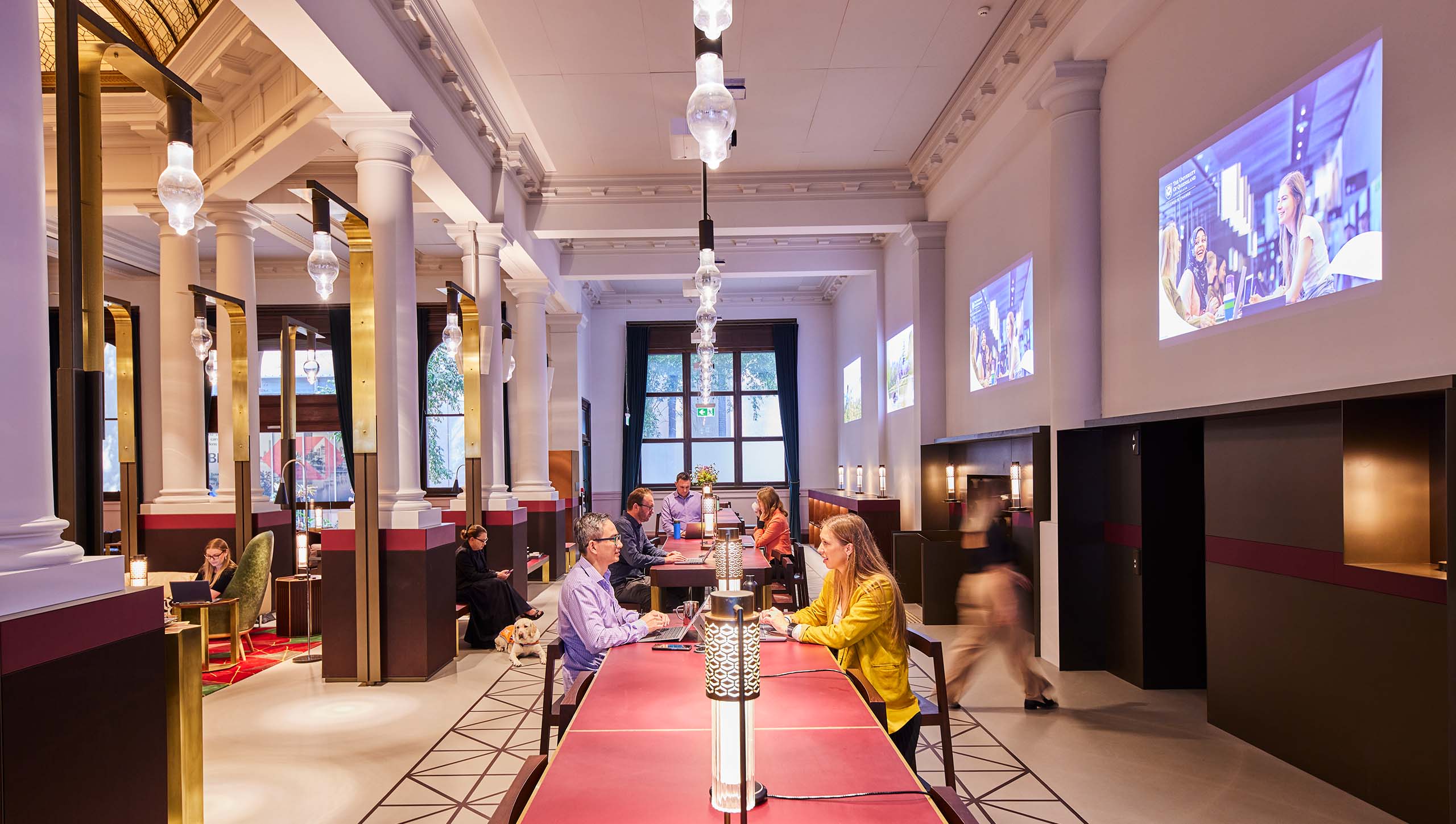 Inside UQ Brisbane City collaboration space with people working on desks