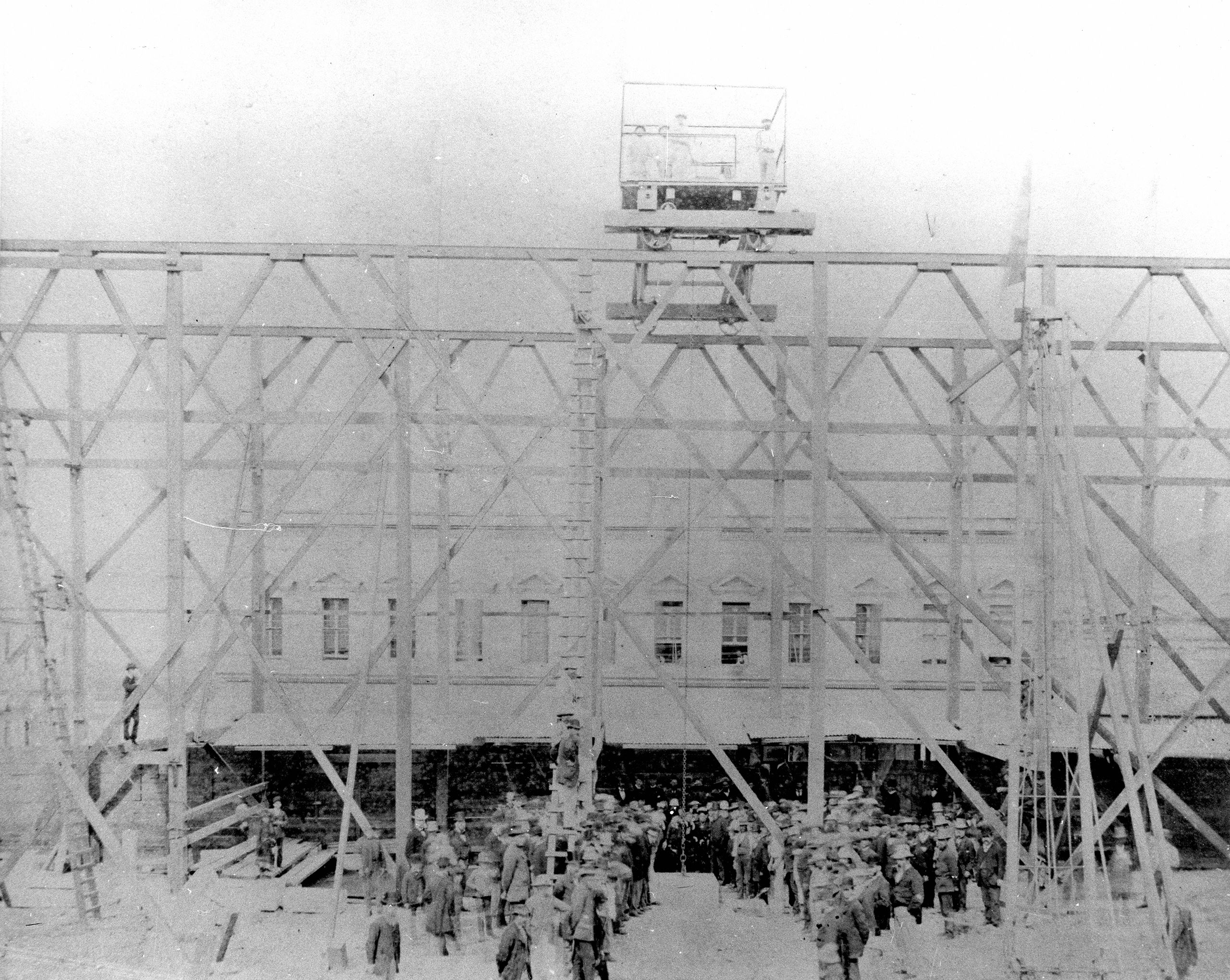 Historical photo showing a crowd gathered at the laying of foundation stone in 1881.