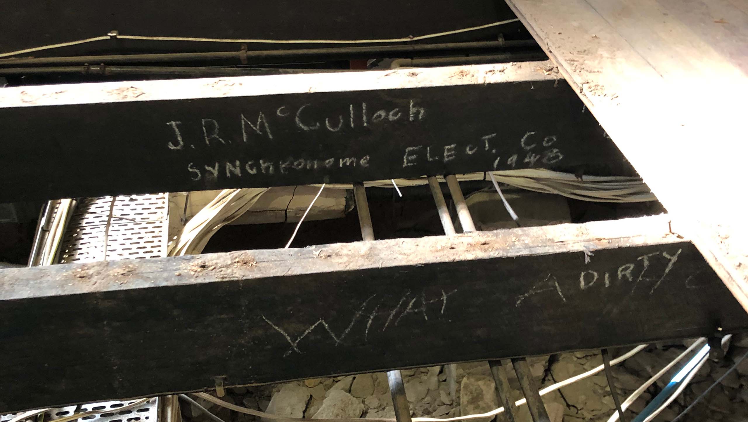 Some graffiti written in chalk under floor boards.