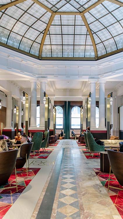 Inside the restored Atrium at UQ Brisbane City, looking at the dome on the ceiling and marble floor.