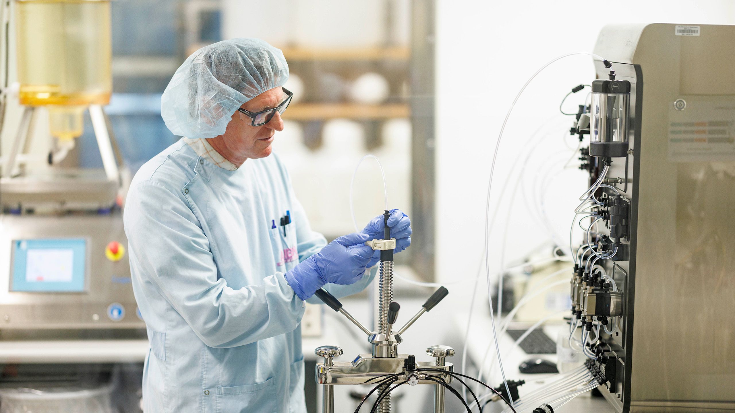 A person wearing protective equipment working in a science laboratory