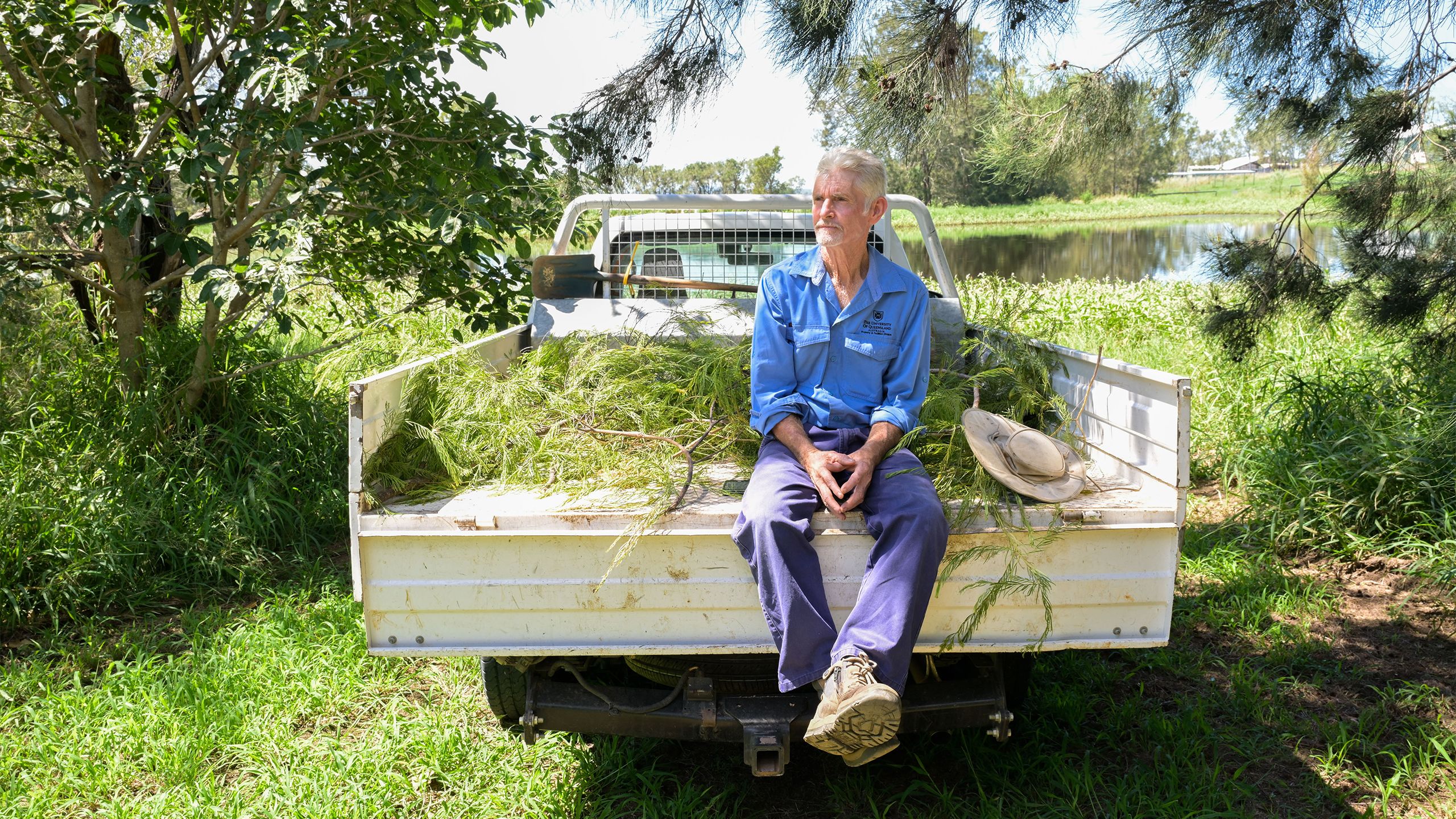 Retiring UQ Gatton grounds supervisor Steve Barakin sitting on the back of his work ute.