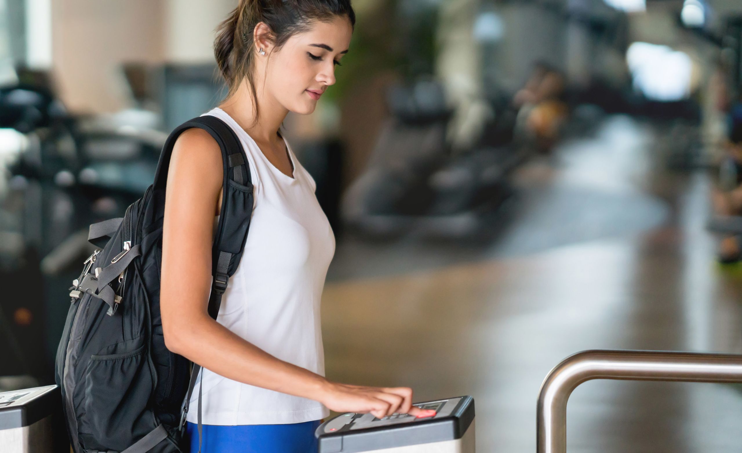 Woman scanning fingerprint at airport