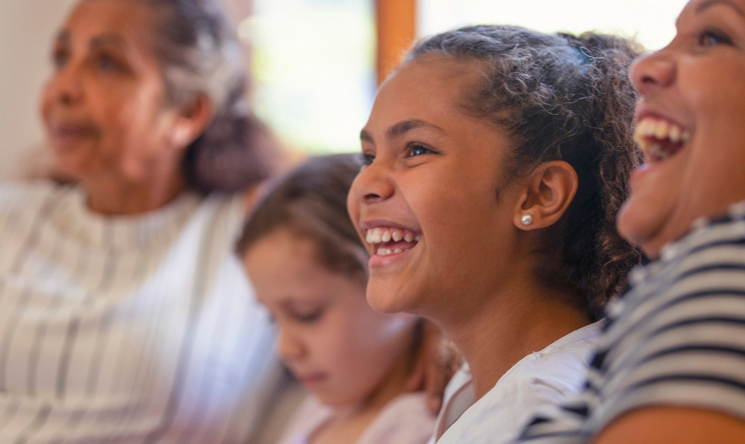 Child laughing with family.