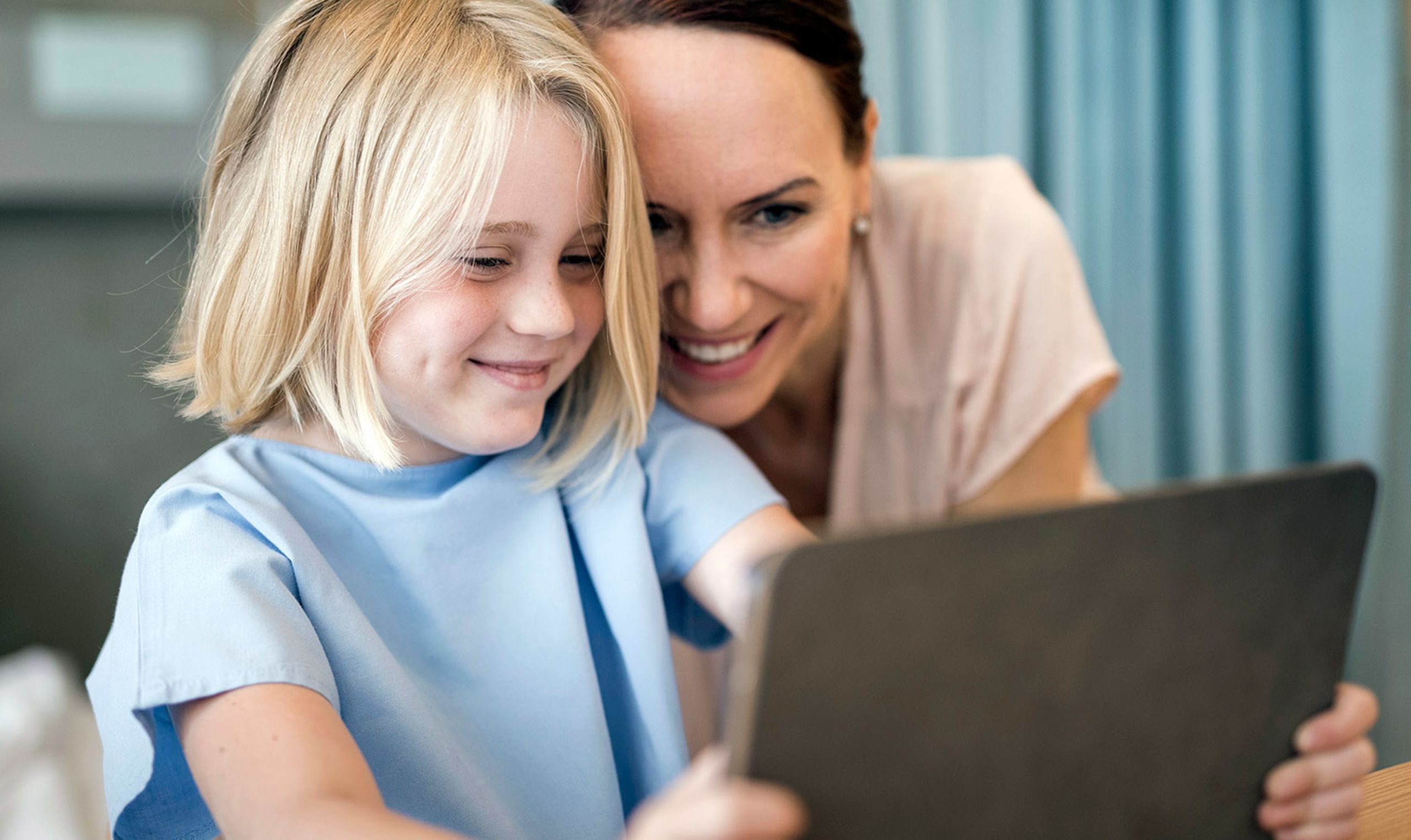 Sick child digital schooling with mum.