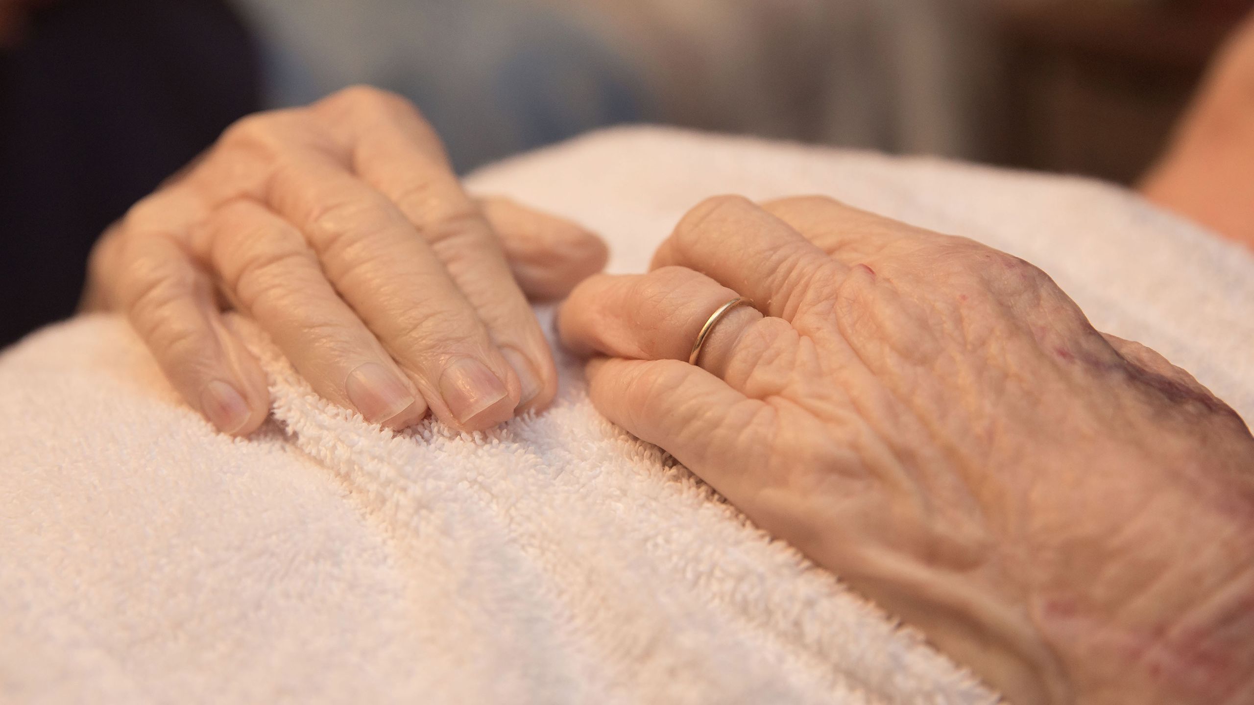 Folded hands of a deceased elderly woman