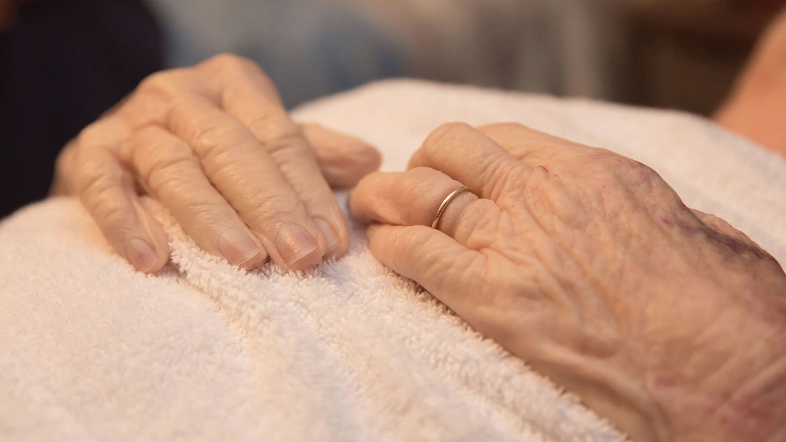 Folded hands of a deceased elderly woman