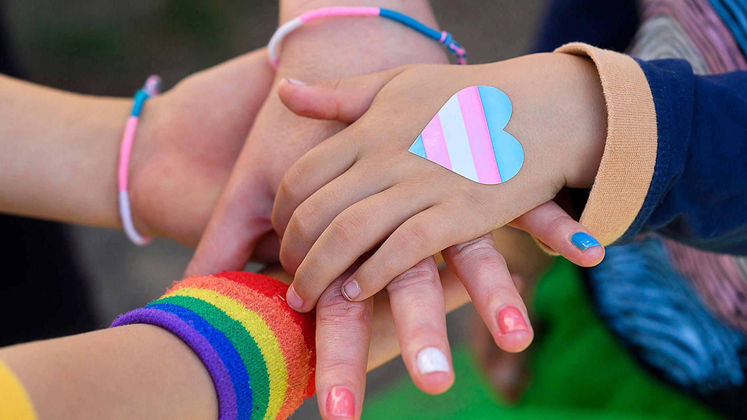 Young people stack hands on top of one another