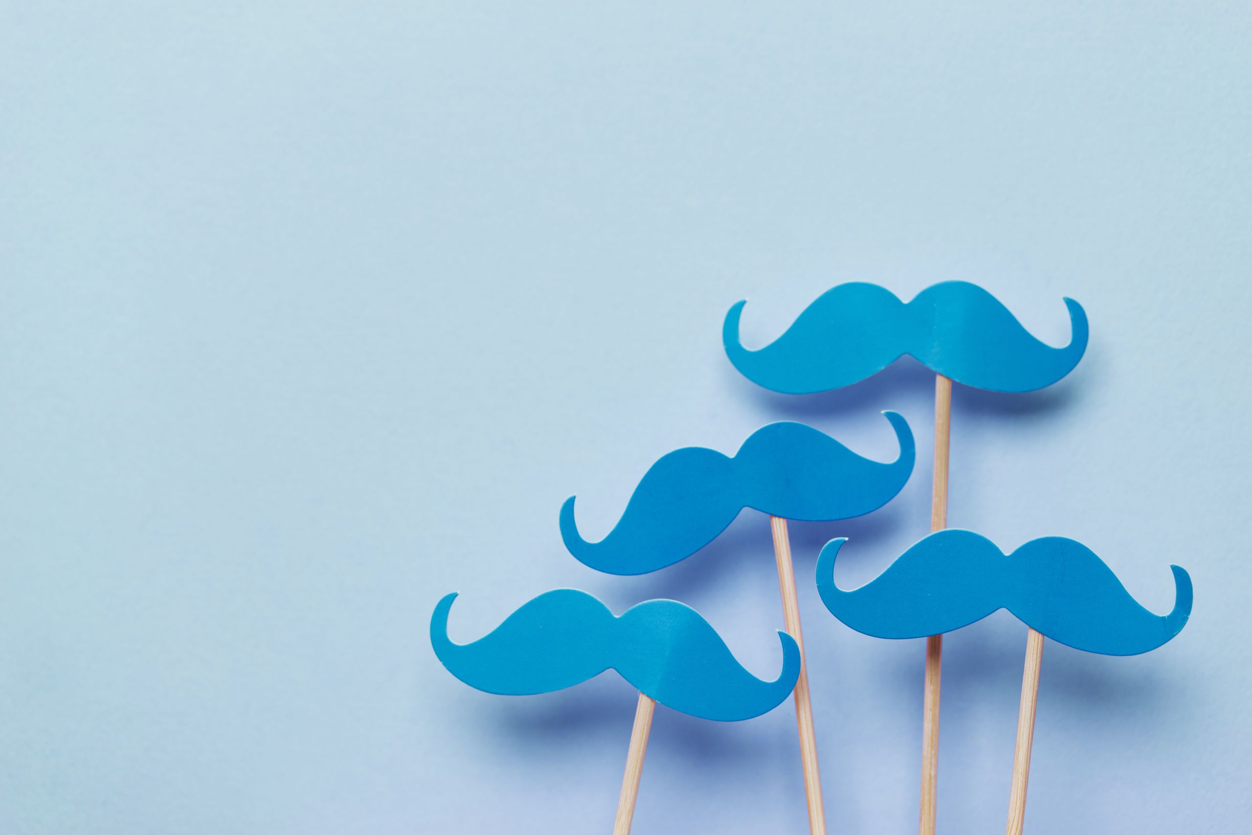 blue moustaches on sticks