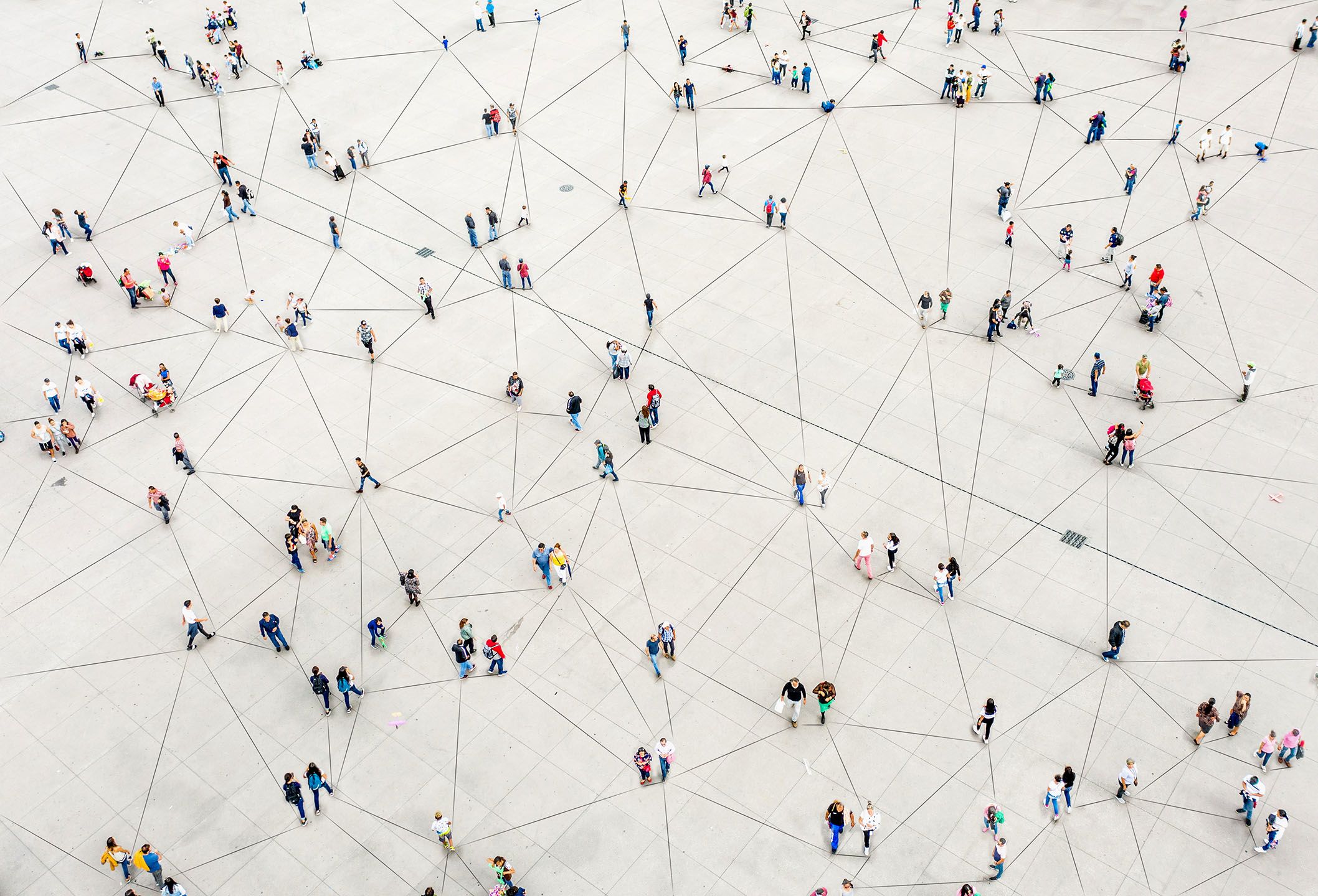 Arial view of people walking from above. People are connected by drawn lines to look like a network